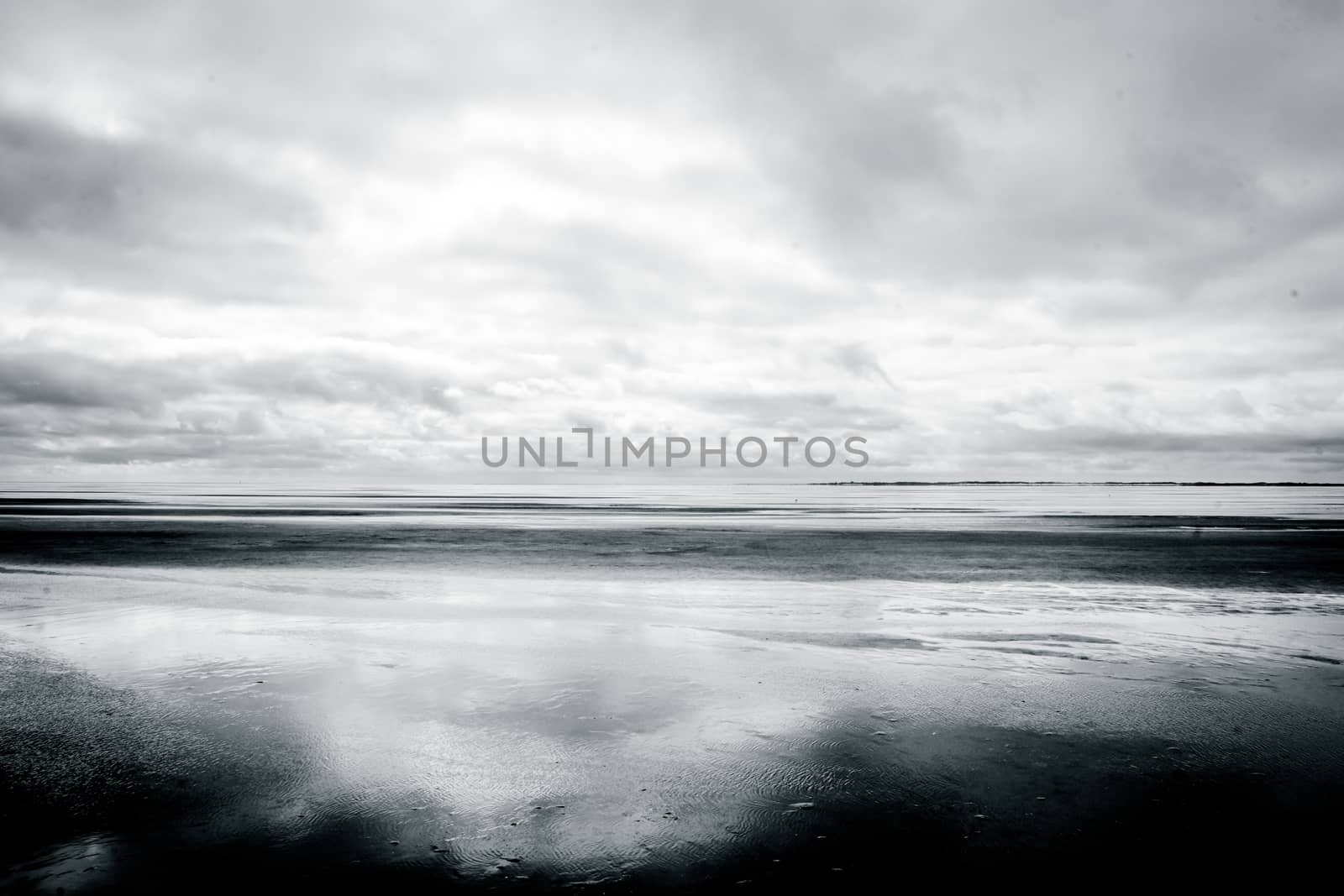 Black and white photograph of low tide beach