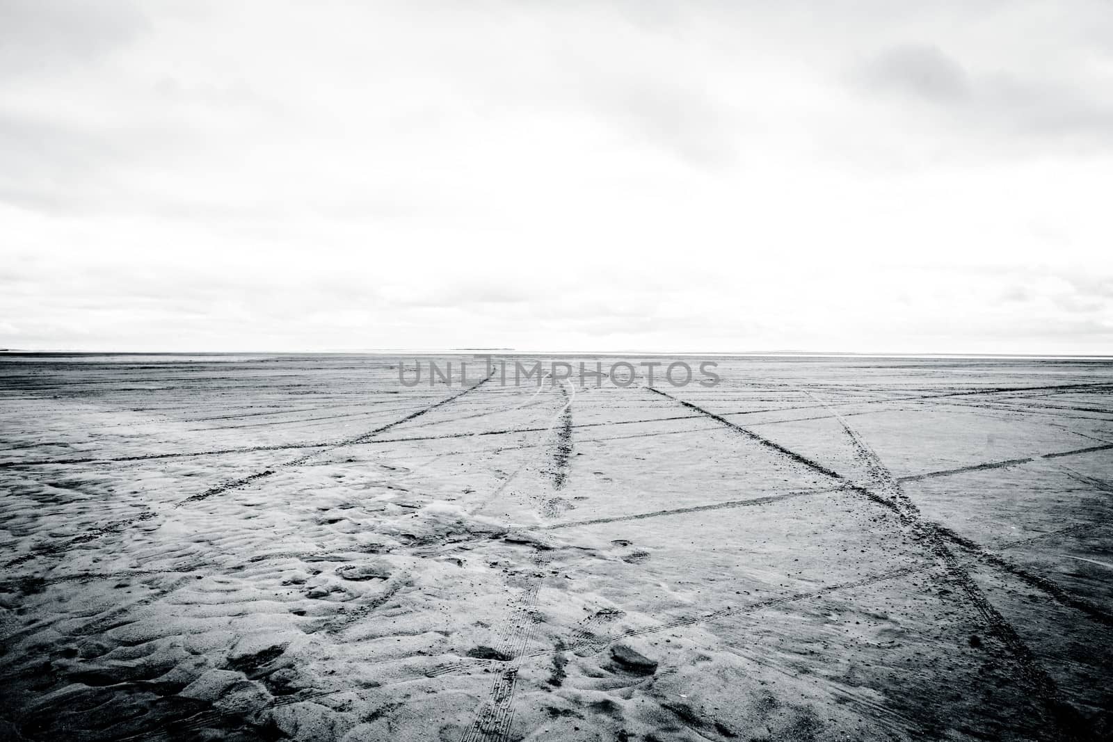 Black and white photograph of low tide beach
