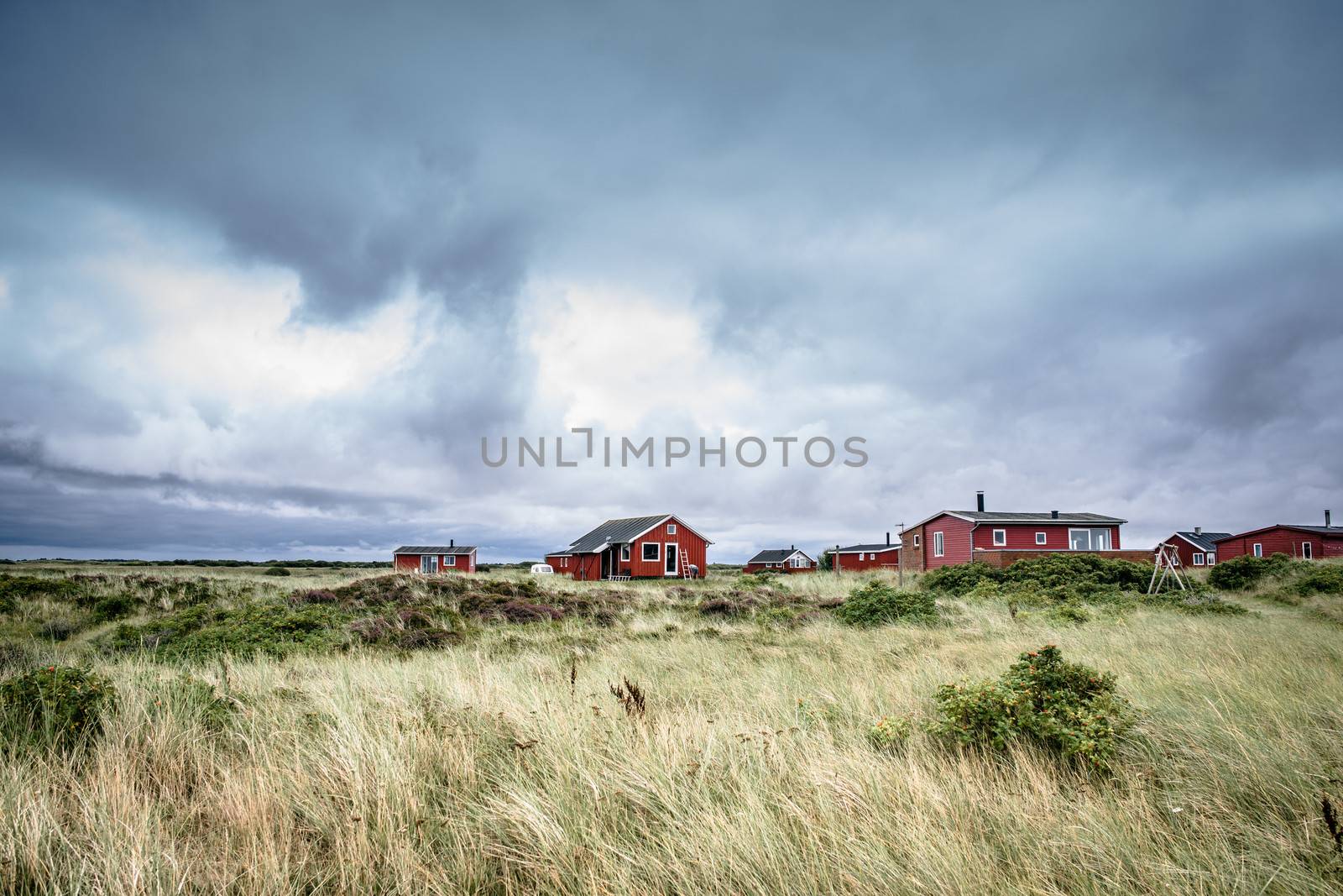 Scandinavian summer cabins in stormy weather