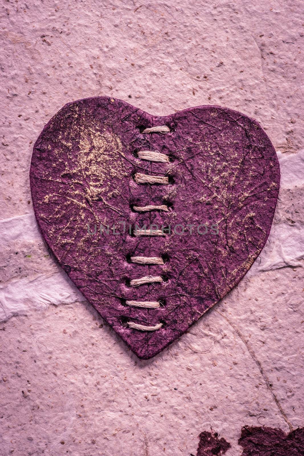 Romantic purple heart on a rough surface