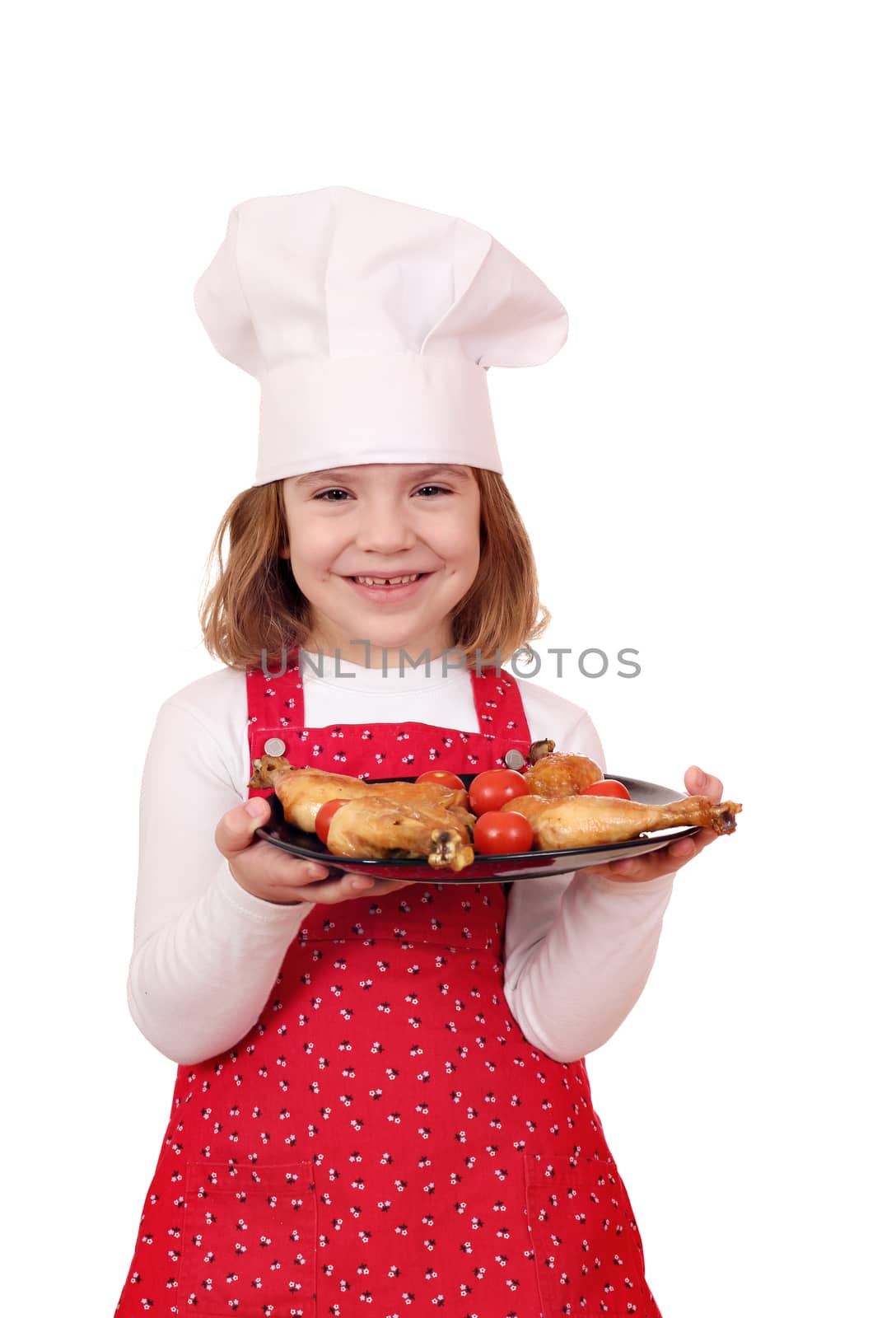 happy little girl cook with chicken drumstick on plate by goce