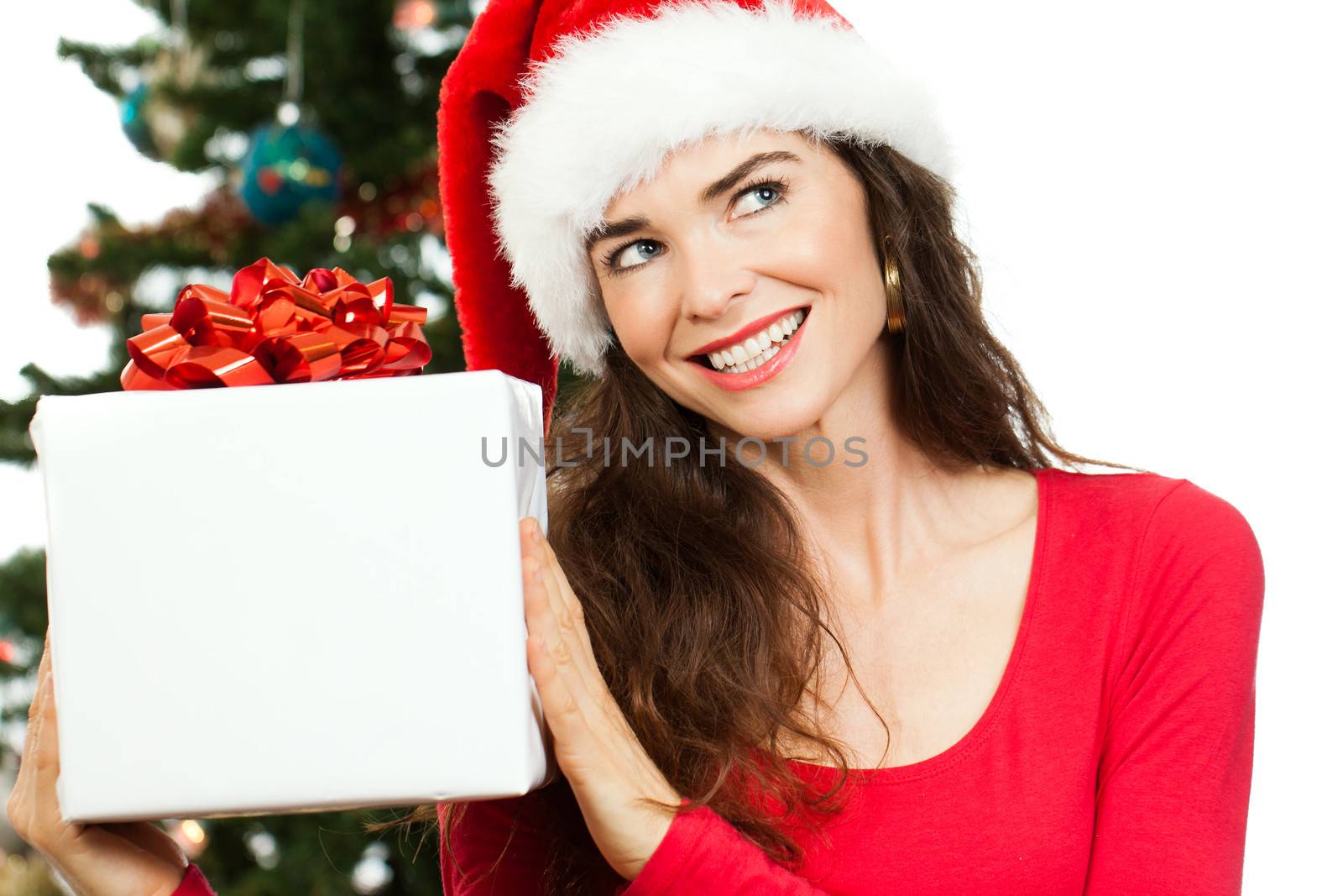 Smiling woman holding Christmas gift by Jaykayl