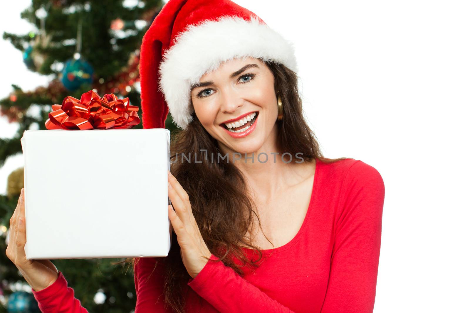 Happy woman holding Christmas gift by Jaykayl