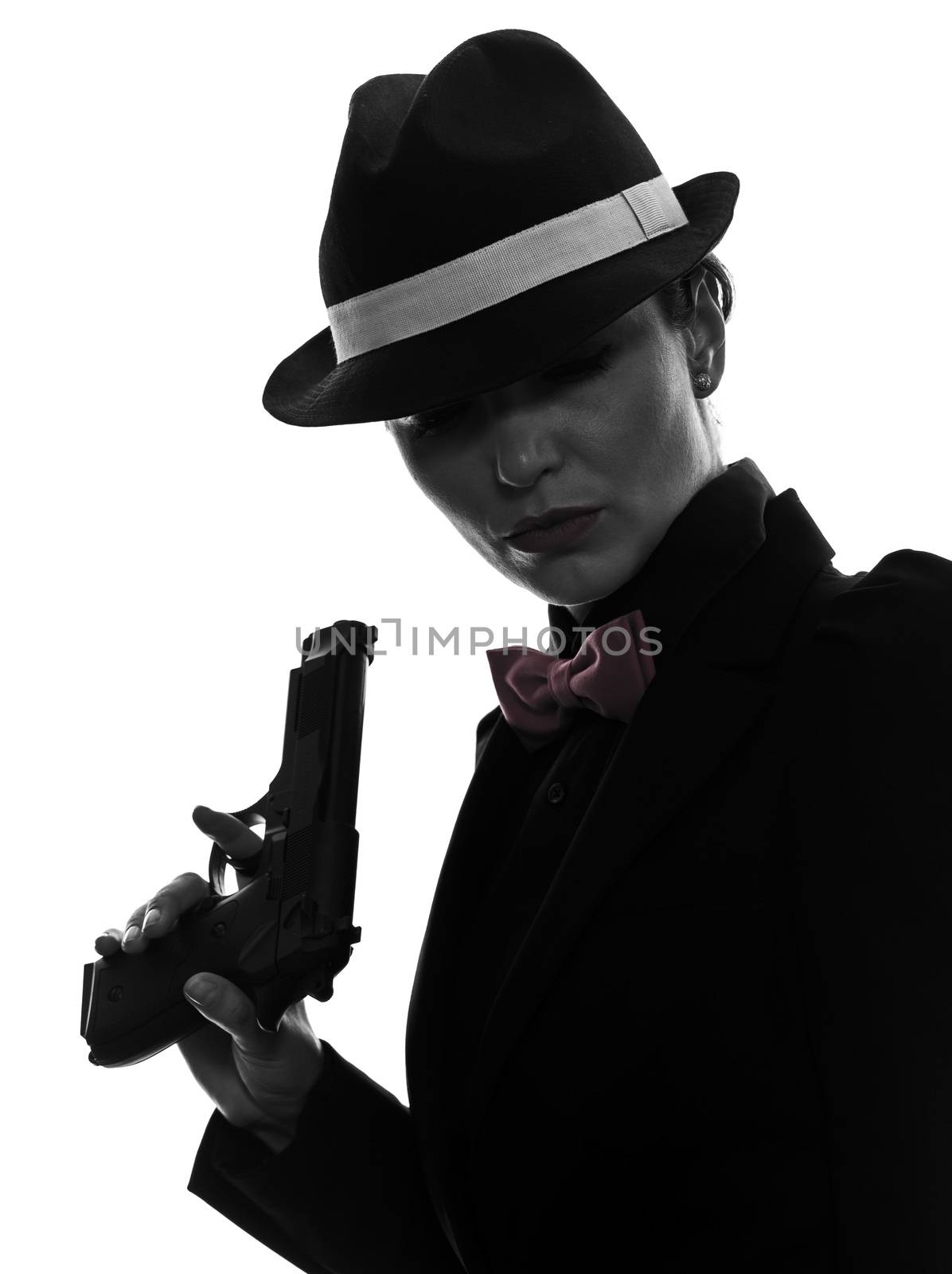 one stylish caucasian woman in suit holding gun in silhouette  on white background