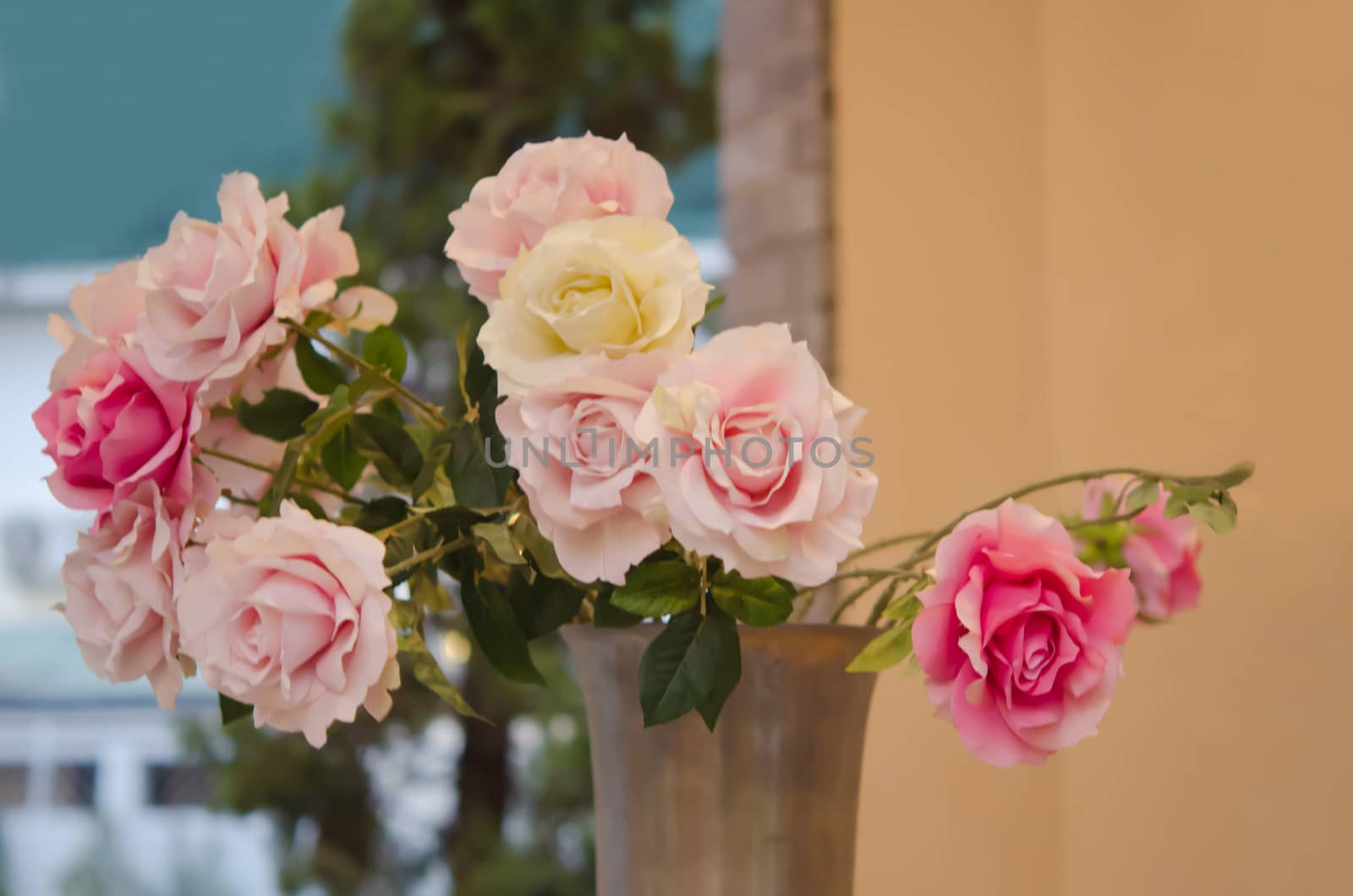 Bouquet of  pink plastic roses  in ceramic vase