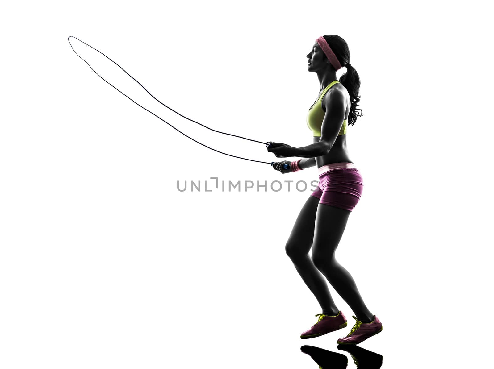 one caucasian woman exercising fitness  jumping rope  in silhouette on white background