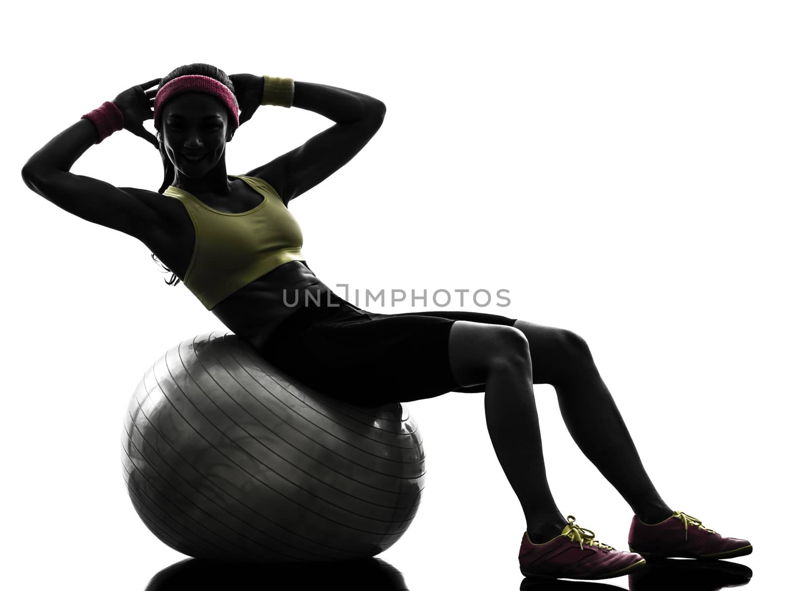 one  woman exercising crunches workout on fitness ball in silhouette  on white background