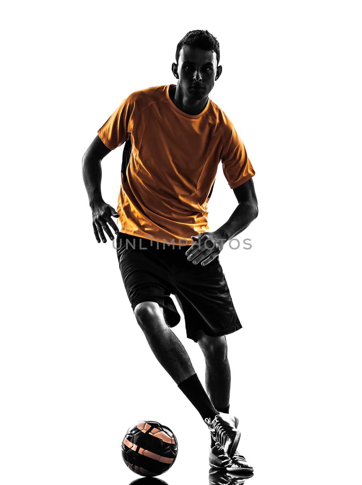 one caucasian young man soccer player orange jersey in silhouette  on white background