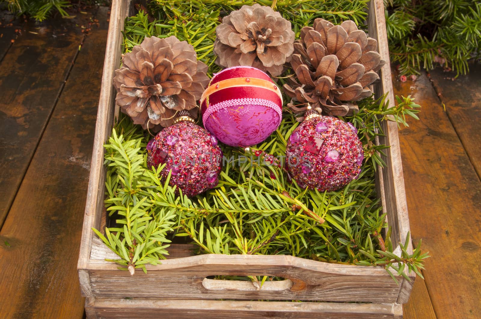 A wooden box with Christmas decorations. Without snow