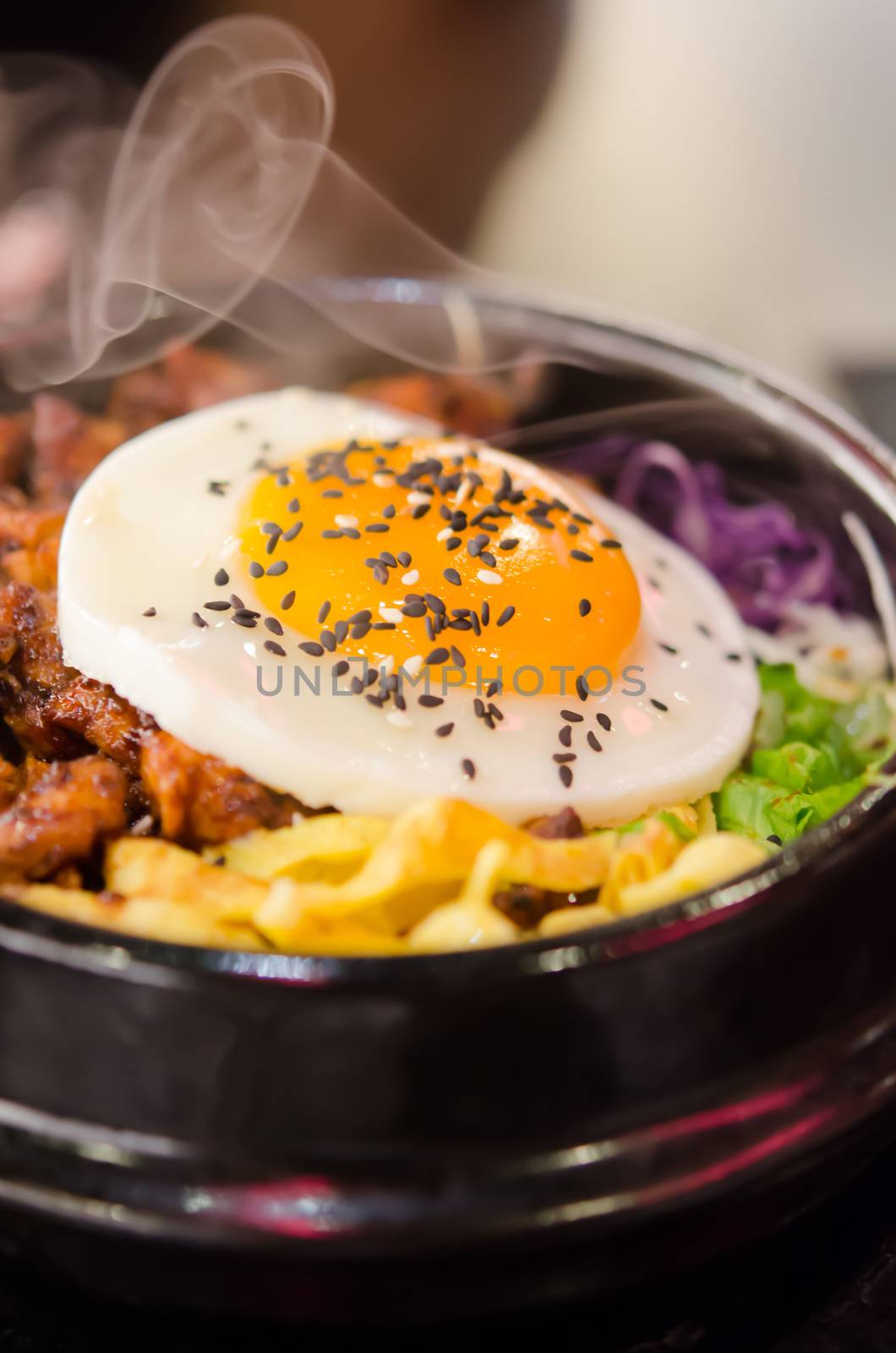 hot bibimbap in a heated stone bowl ,  korean style food