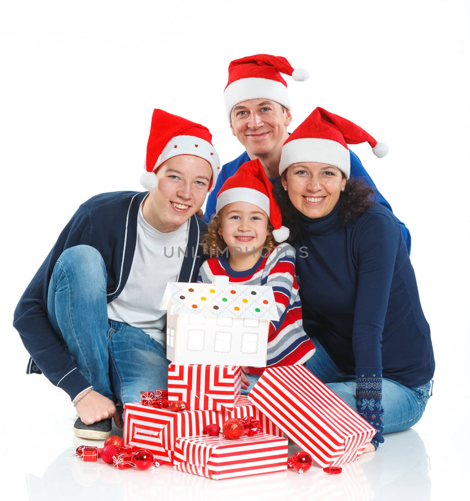 Christmas theme - Portrait of friendly family in Santa's hat with gift box, isolated on white