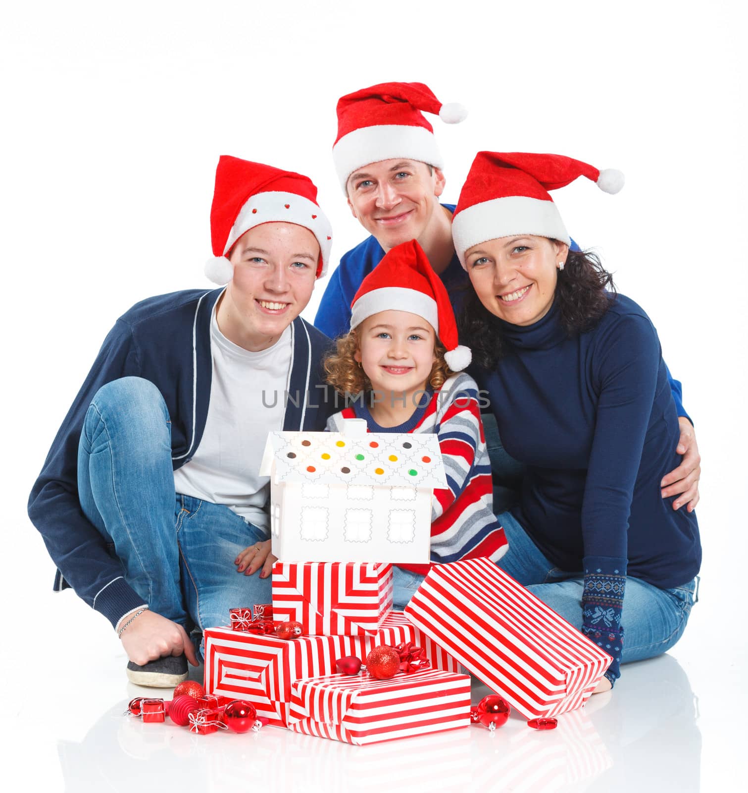 Family in Santa's hat with gift box by maxoliki