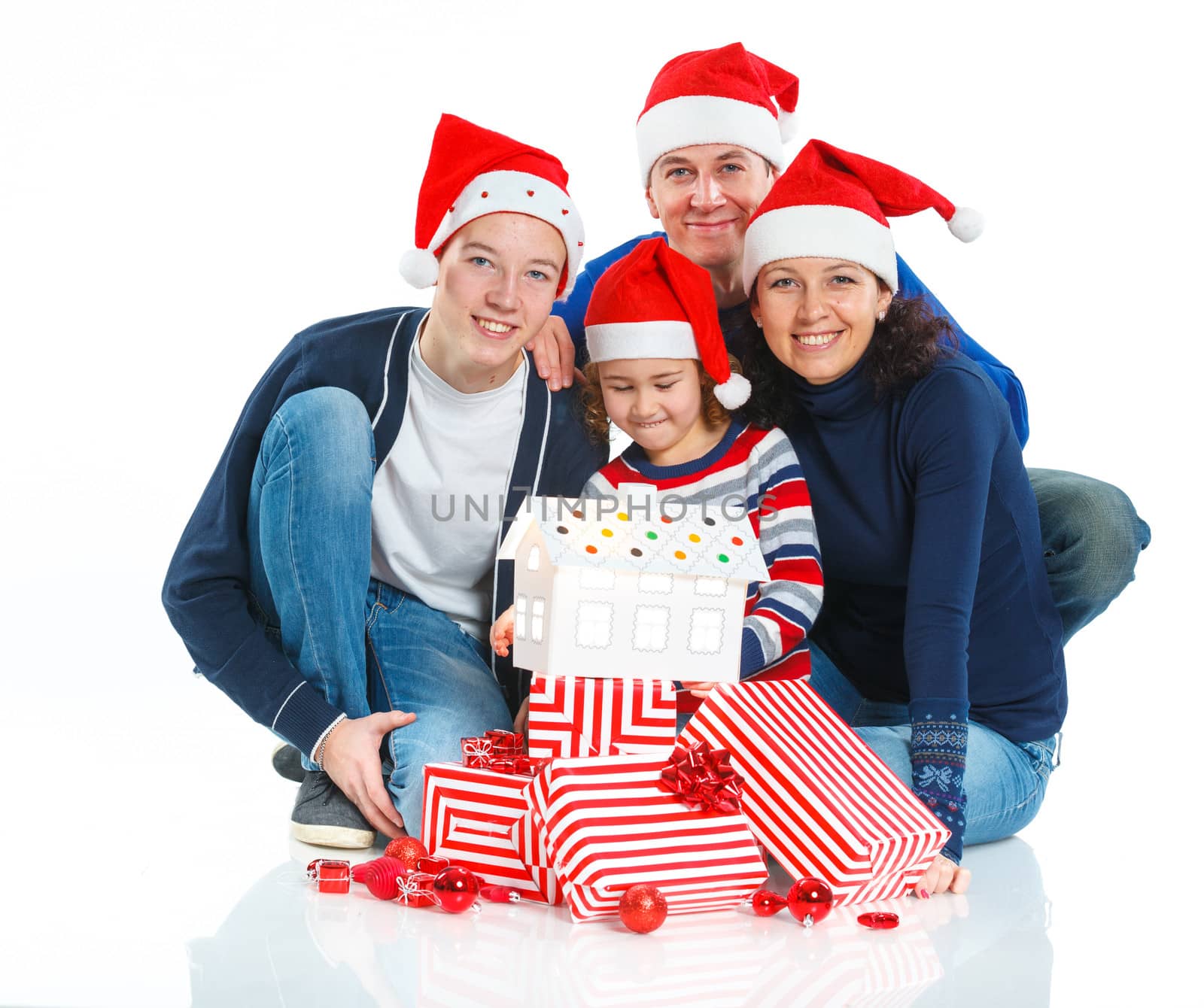 Christmas theme - Portrait of friendly family in Santa's hat with gift box, isolated on white