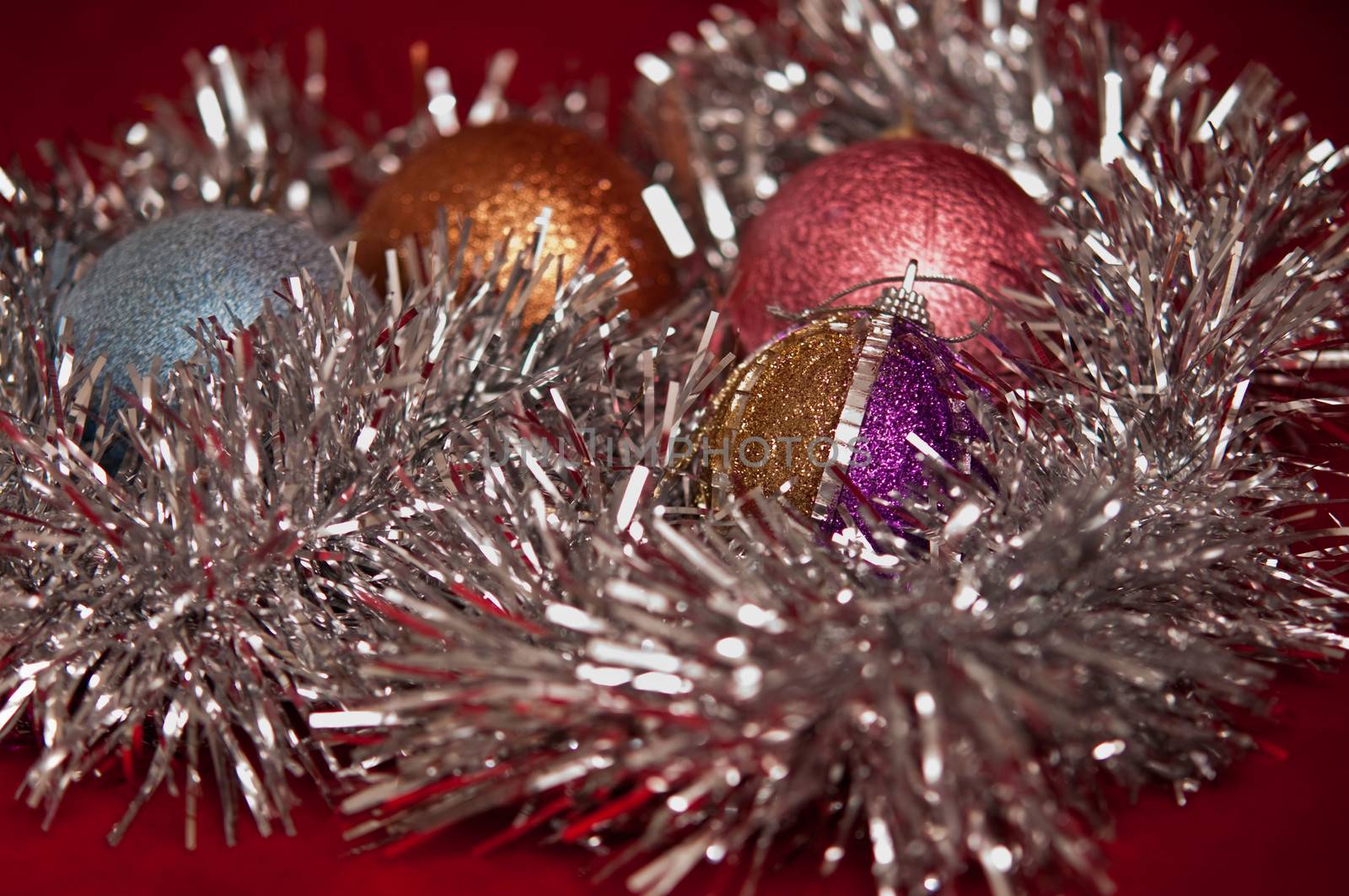 Varicoloured christmas balls on red  background  .