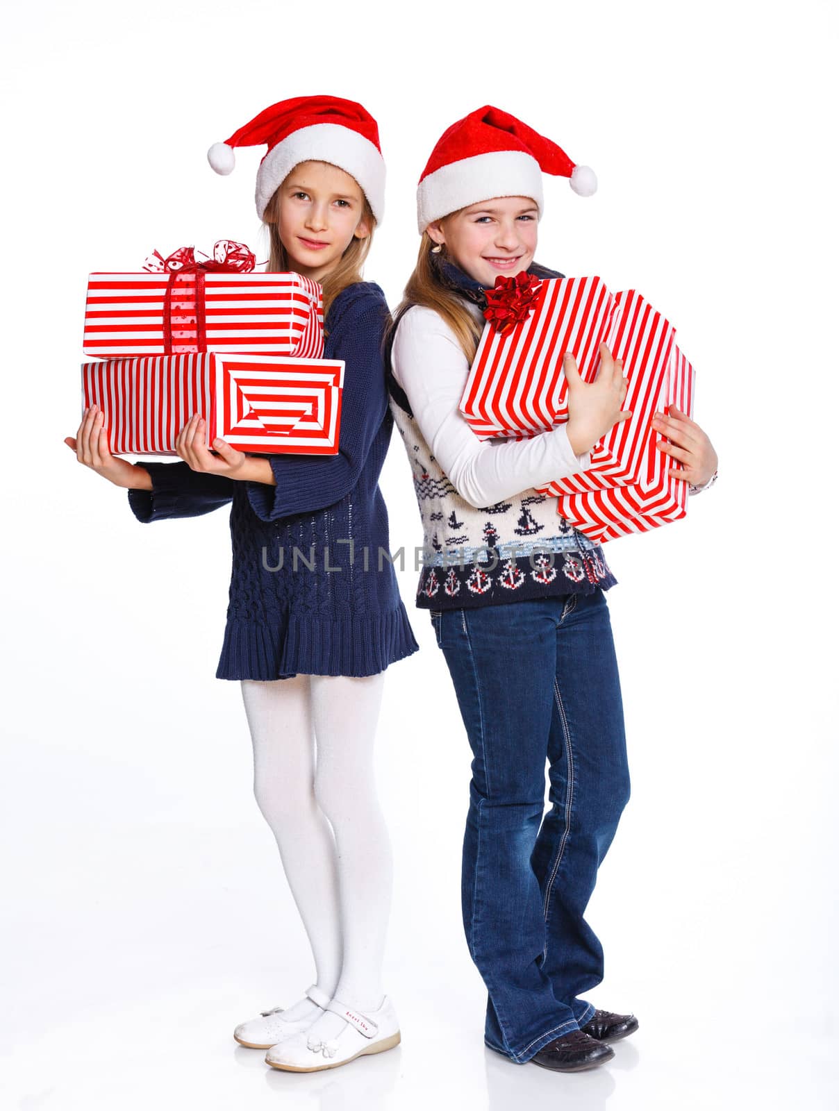 Christmas theme - Two smiling girl in Santa's hat with gift box, isolated on white