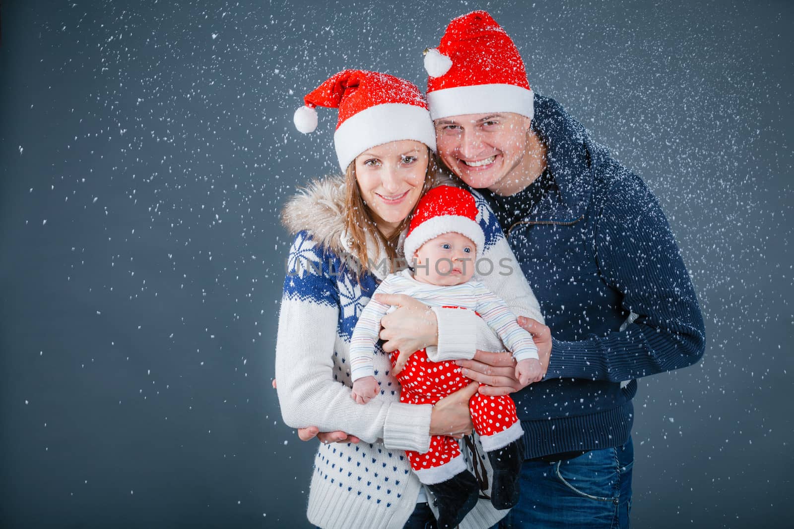 Portrait of happy family in Santa's hat by maxoliki