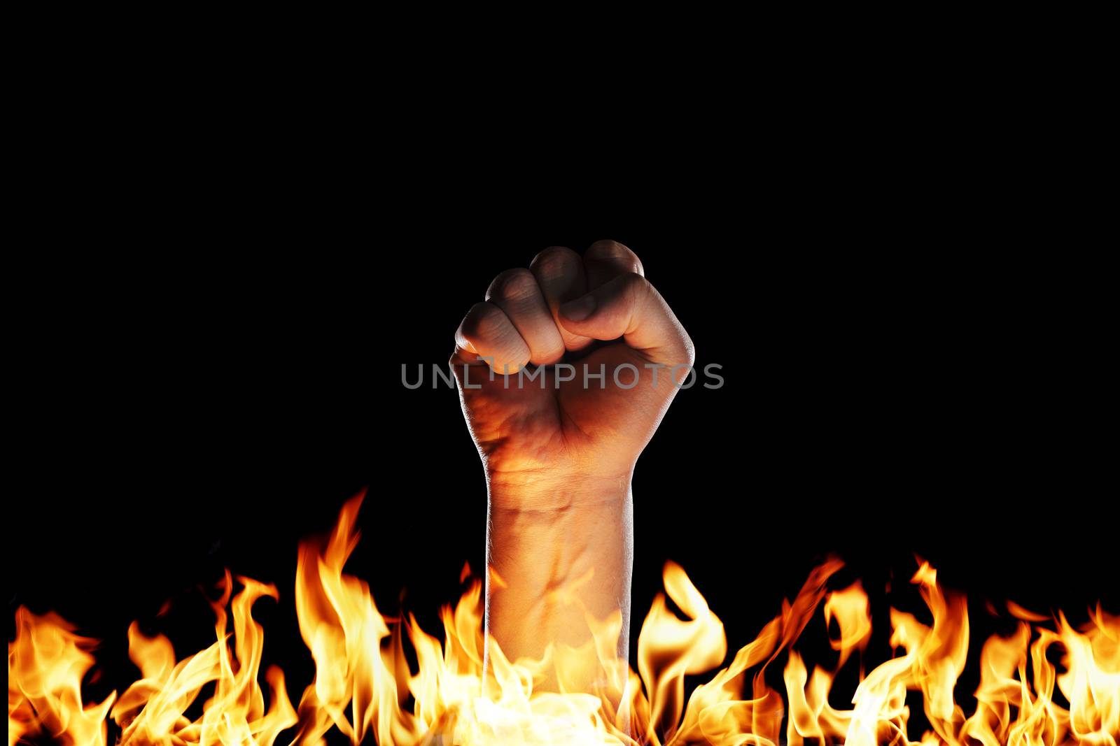 Hand in a fist emerging from a sea of fire.