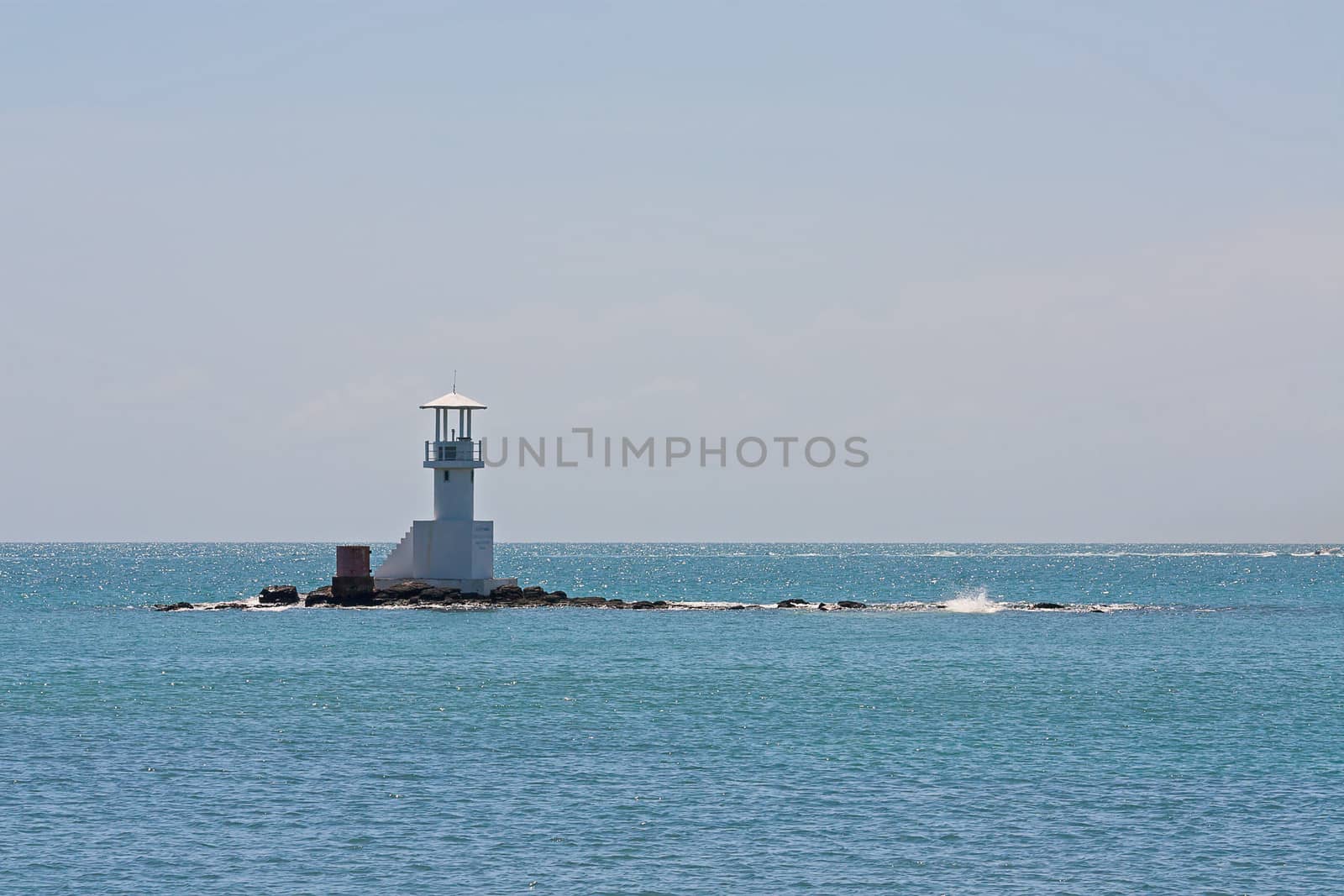 Lighthouse in  Andaman Sea on  background of blue sky, Thailand.