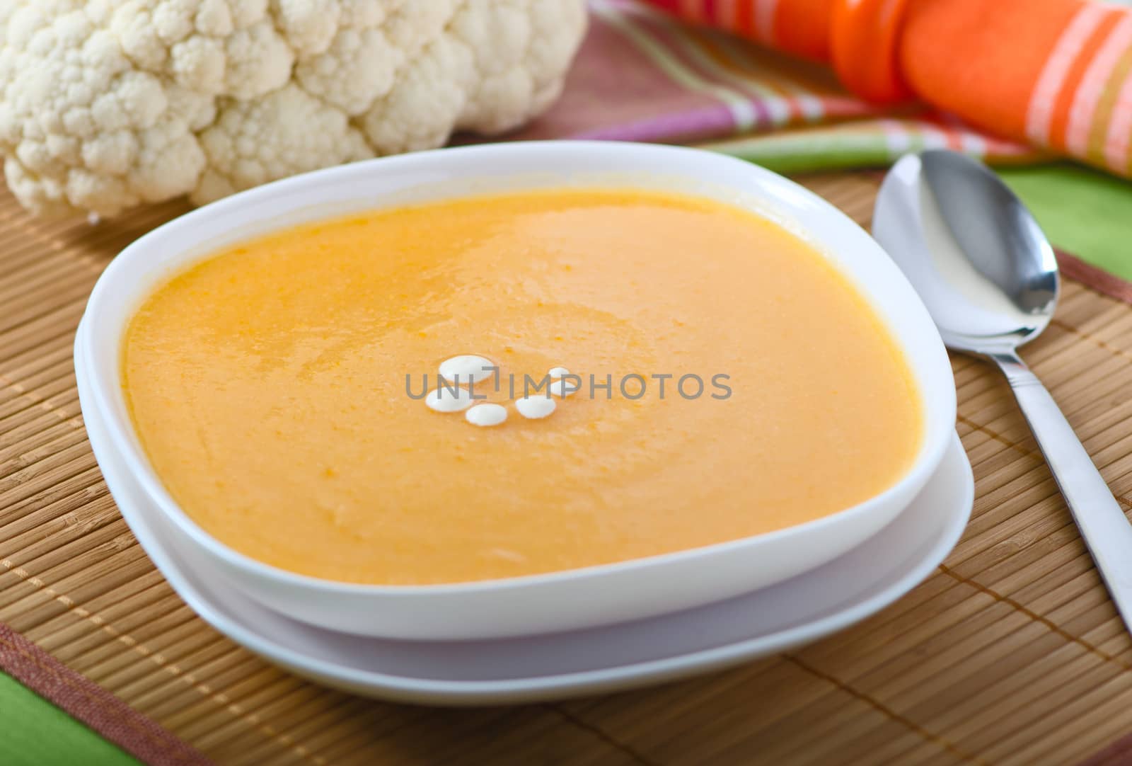 Vegetable soup in a plate with cauliflower, carrots, potatoes and onions