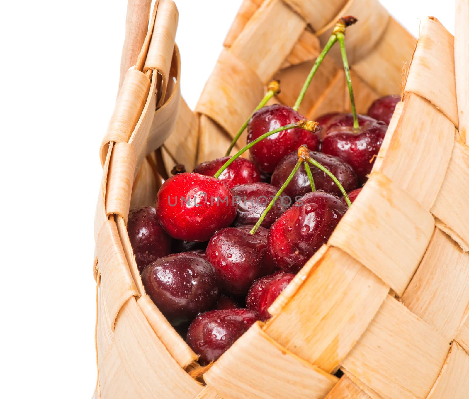 Sweet cherry in basket isolated on white background