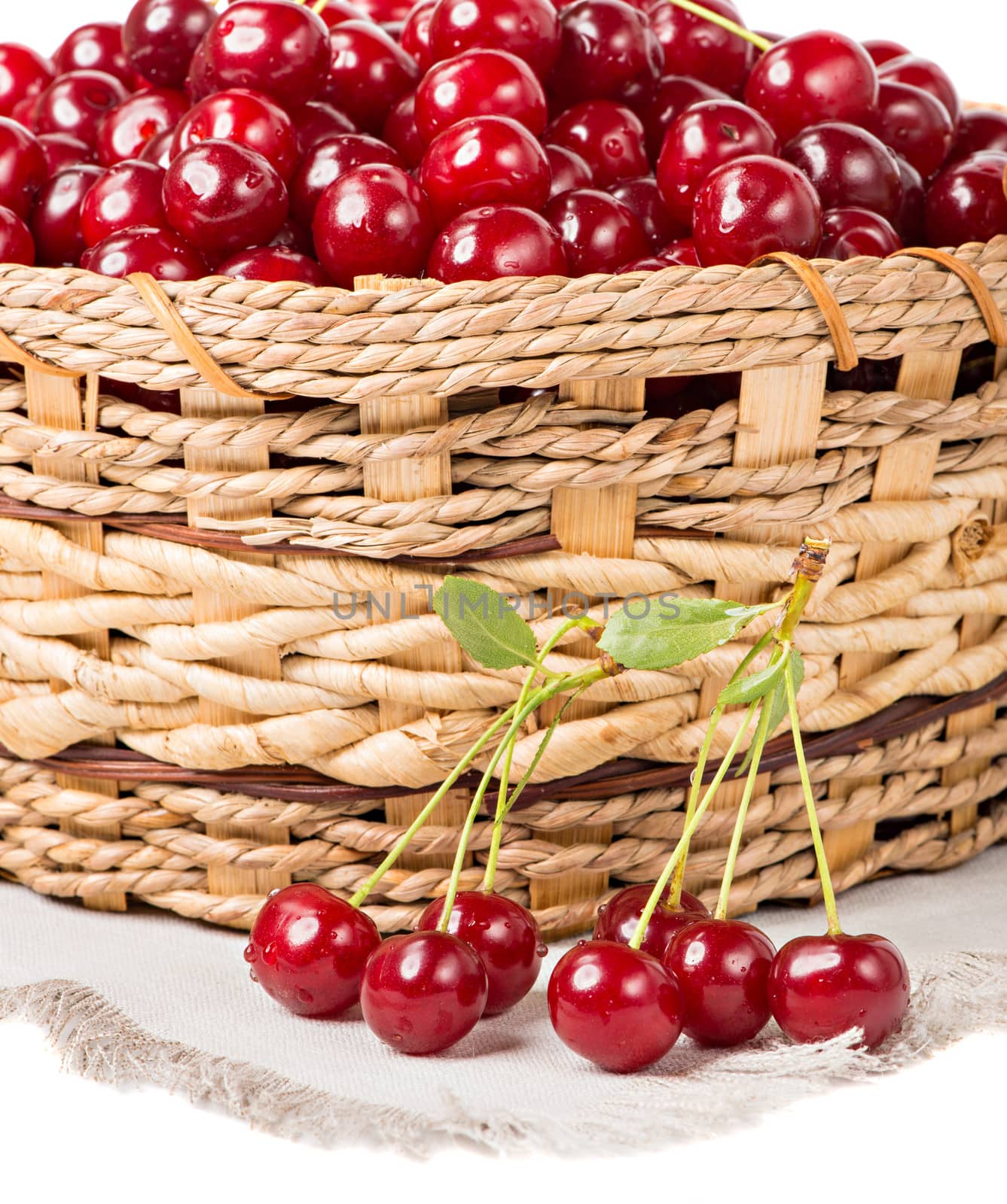 Sweet cherry in basket isolated on white background