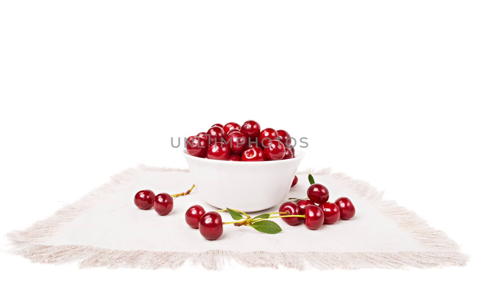 Sweet juicy cherries in a bowl on the napkin by Draw05