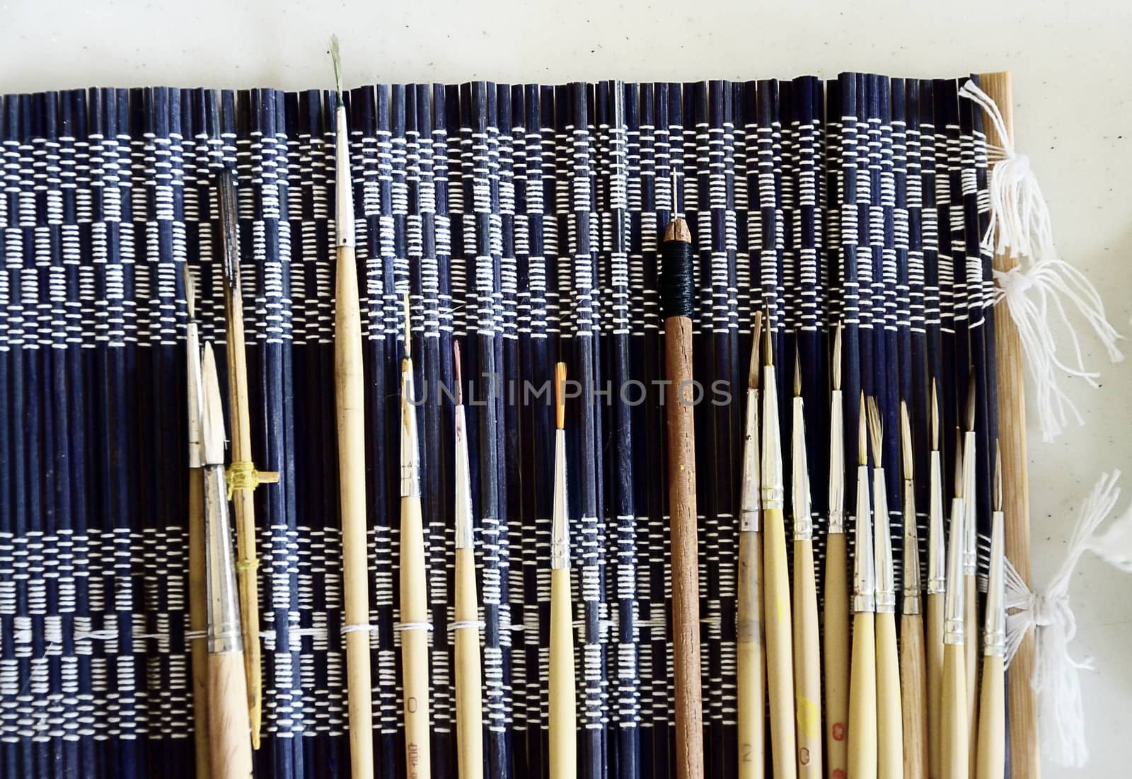 Paintbrush set on fabric background

