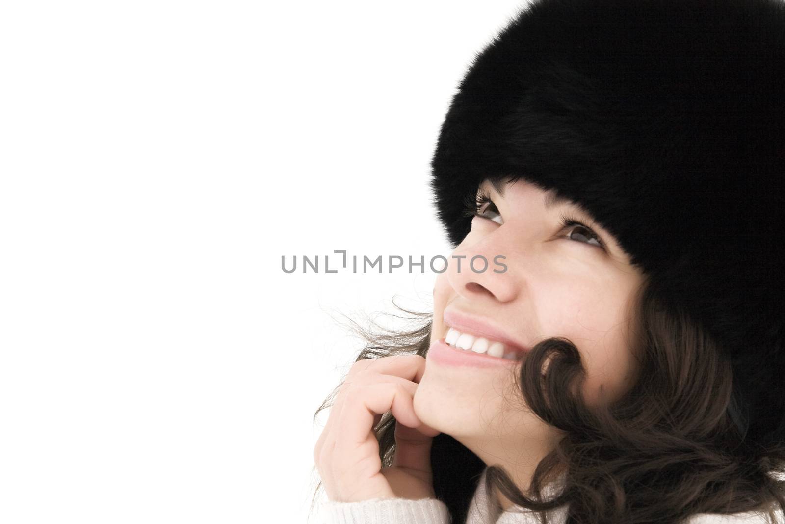 attractive smiling girl in warm fur hat on a white background by Serp
