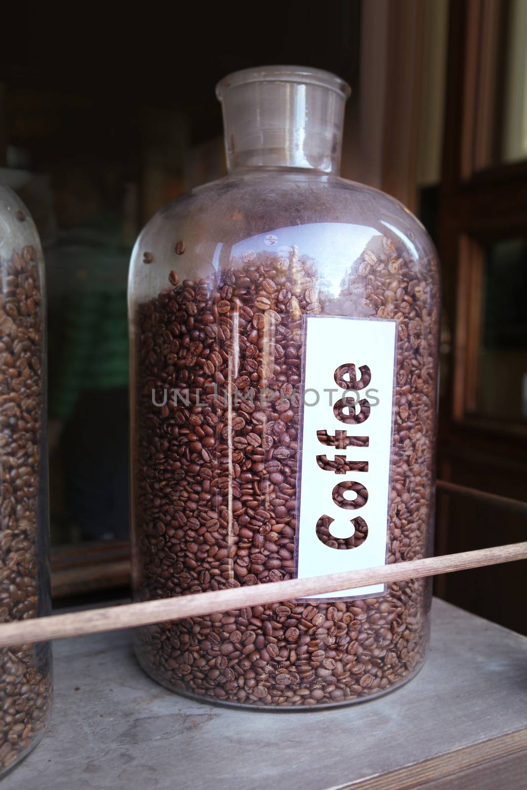 coffee grains in glass vessel on the wooden shelf