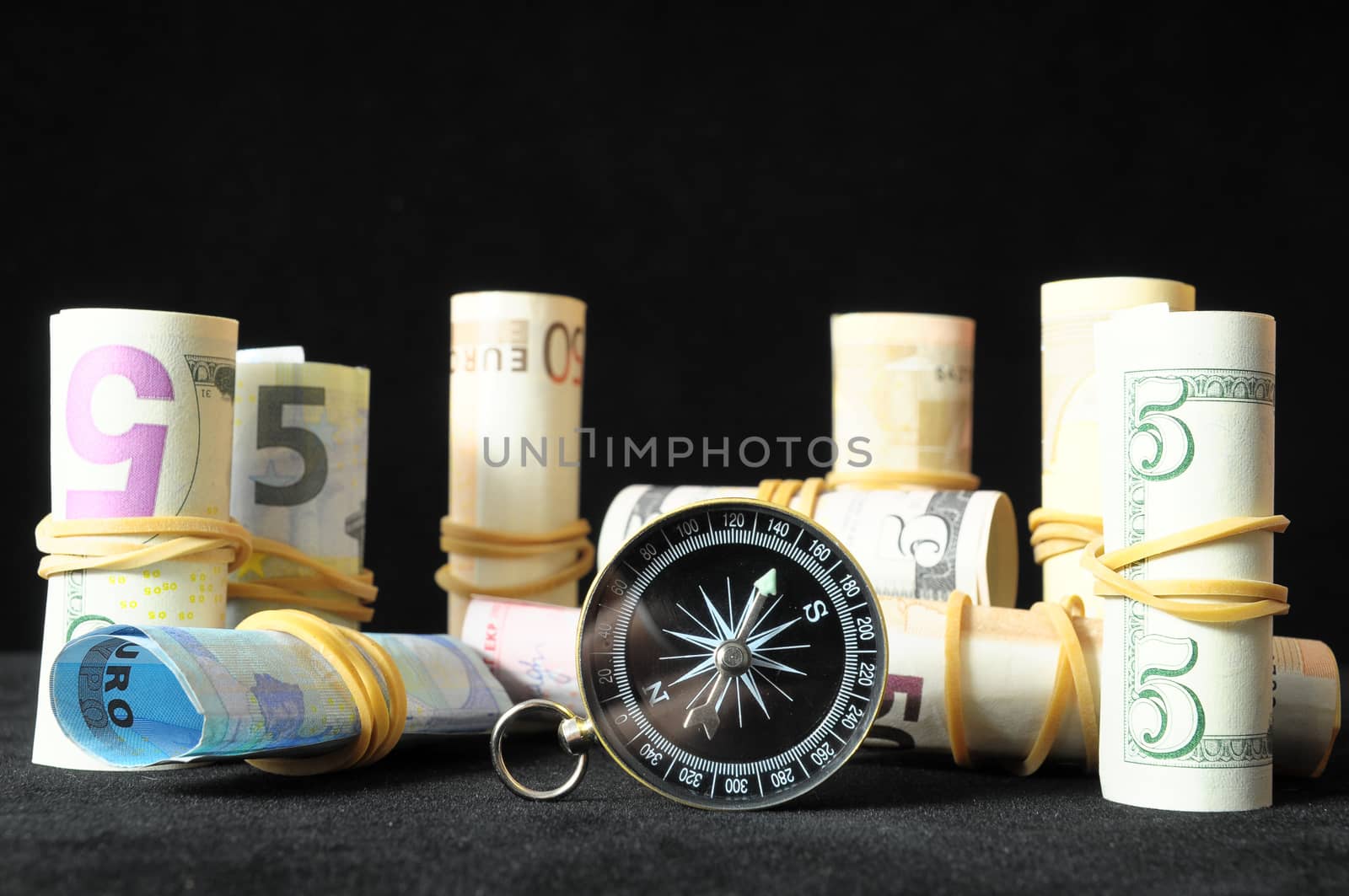 Orientation in  Business Compass and Money on a Black Background