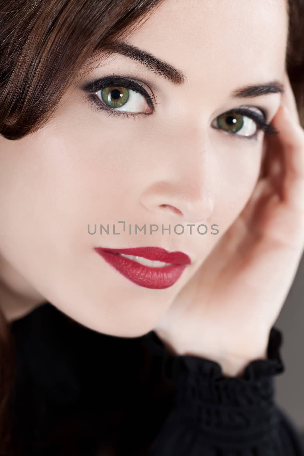Close-up portrait of a beautiful middle aged woman with beautiful red lips