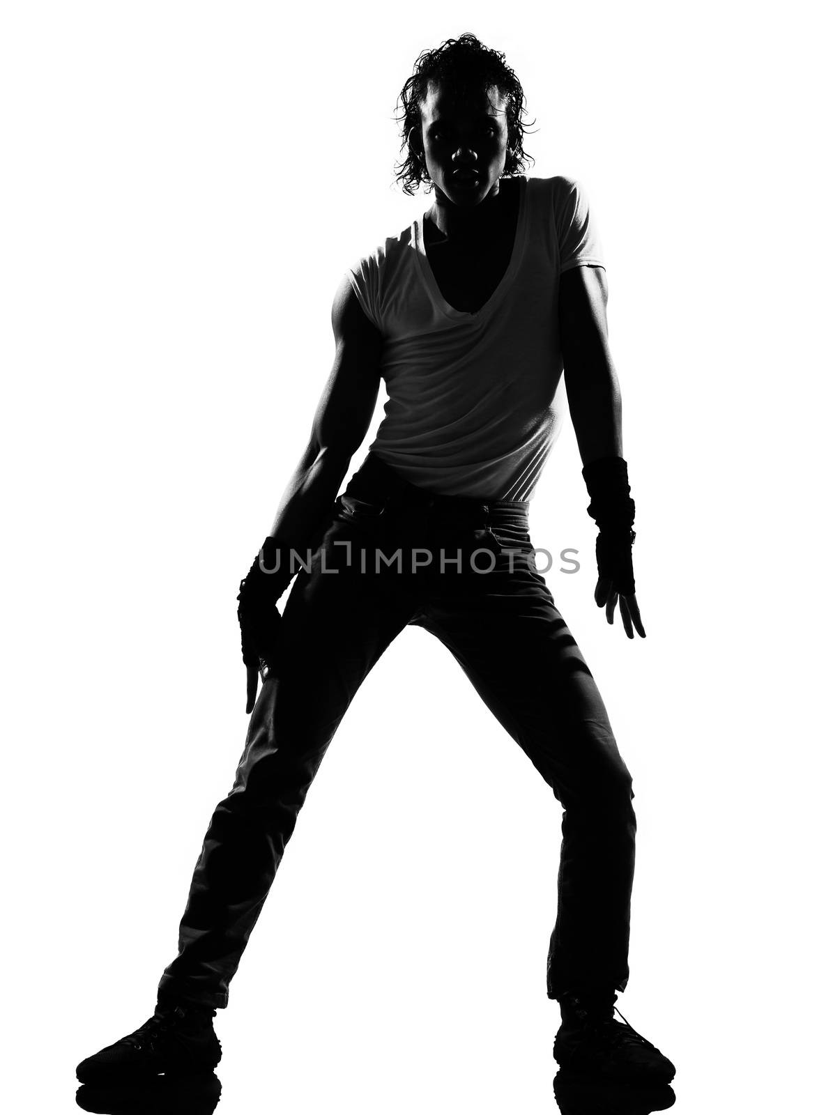 full length silhouette of a young man dancer dancing funky hip hop r&b on  isolated  studio white background