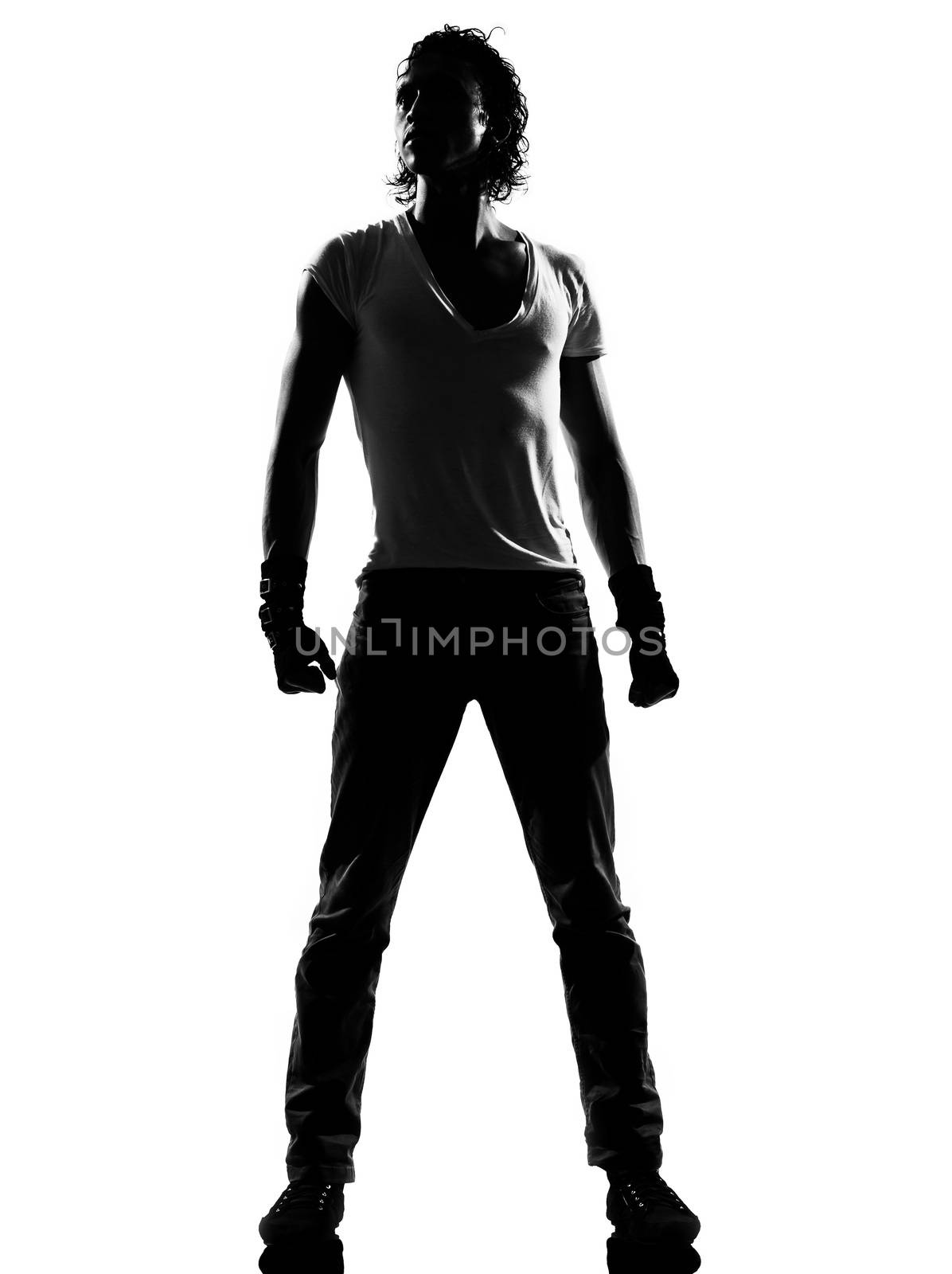 full length silhouette of a young man dancer dancing standing funky hip hop r&b on  isolated  studio white background