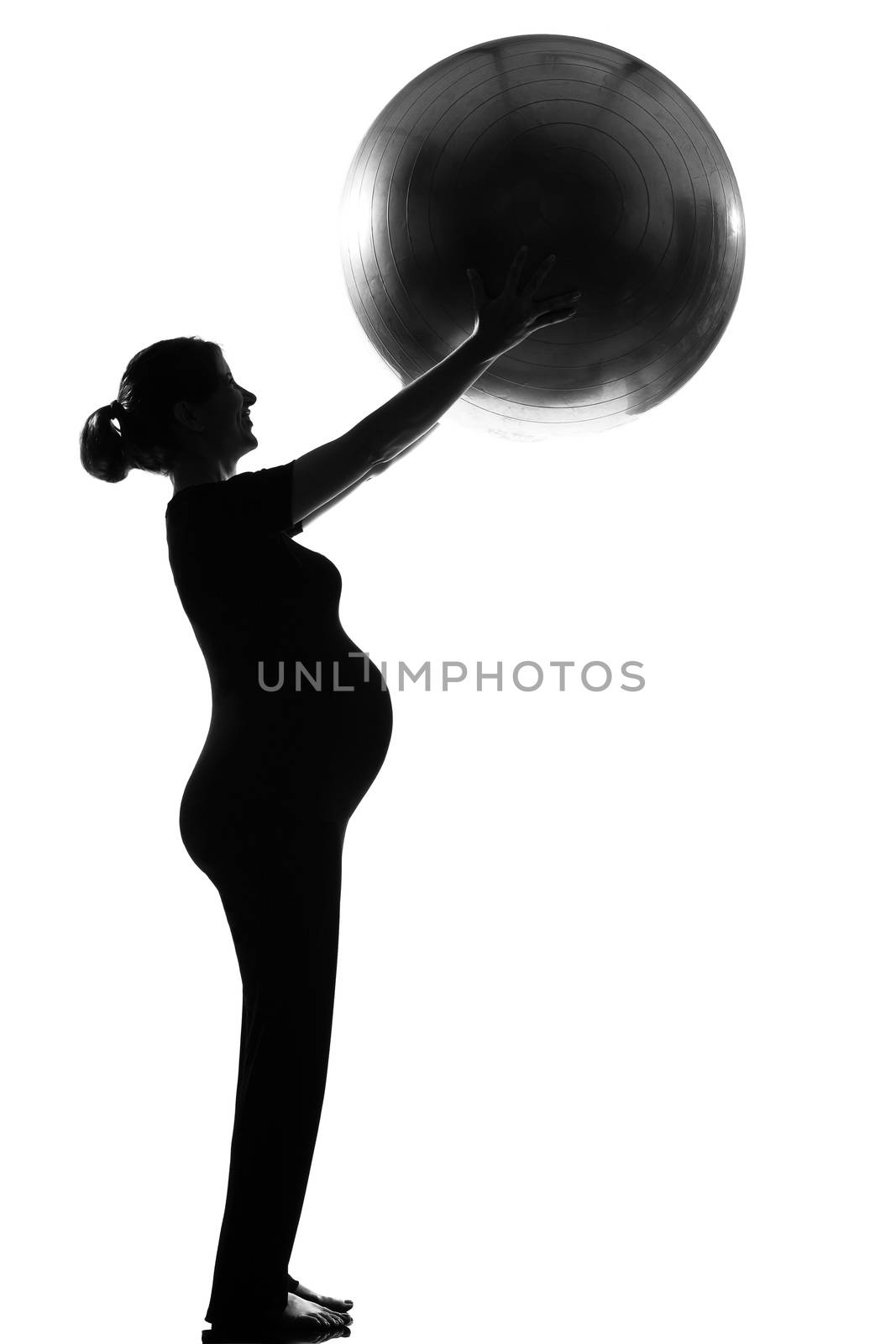beautiful caucasian pregnant woman with fitness ball in full length silhouette on studio isolated white background
