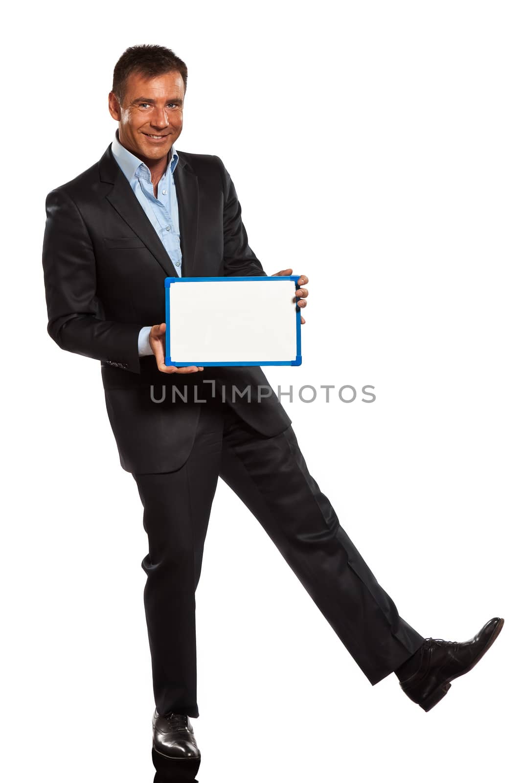 one caucasian business man holding showing whiteboard full length in studio isolated on white background