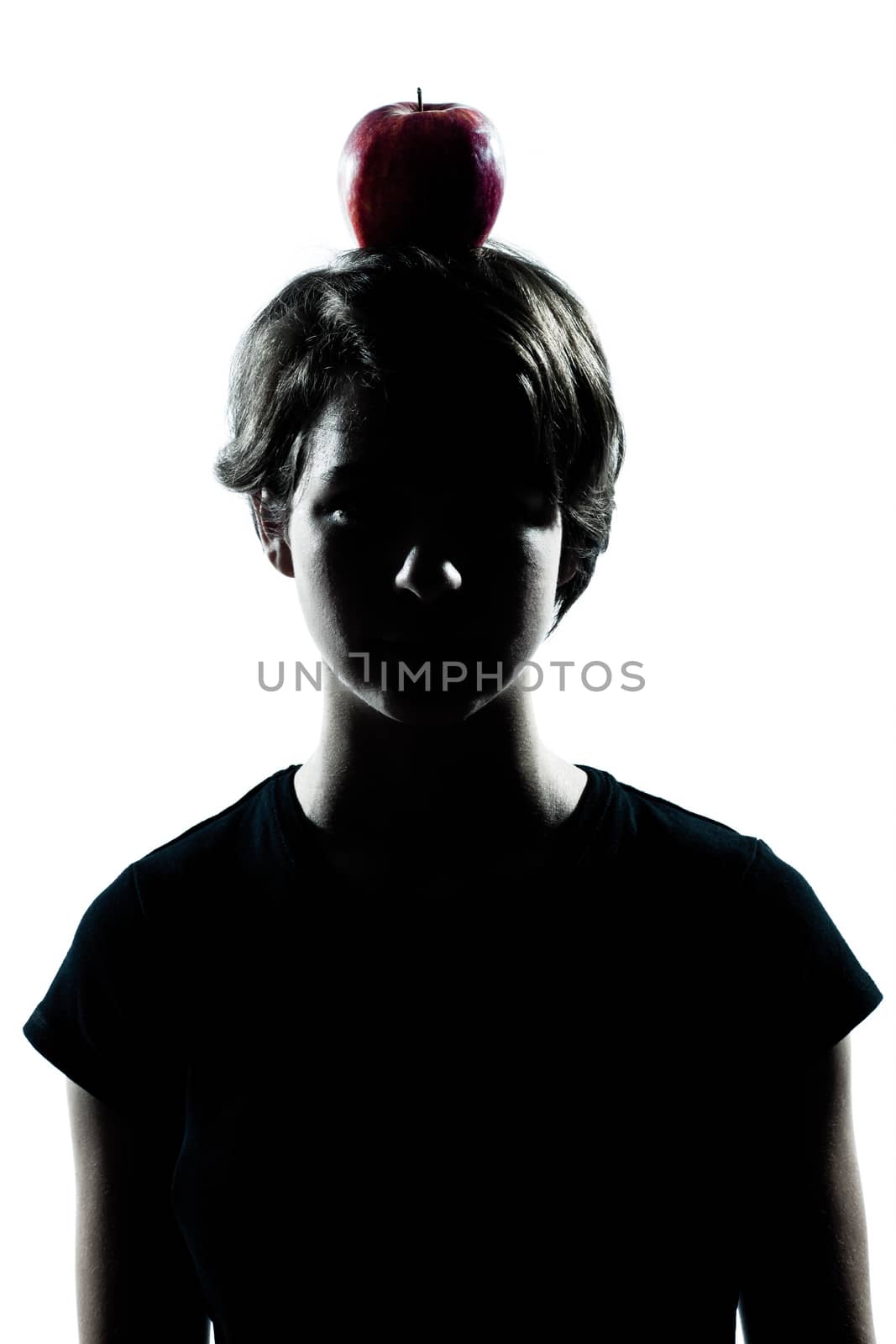 one caucasian young teenager silhouette boy or girl with an apple on his head portrait in studio cut out isolated on white background