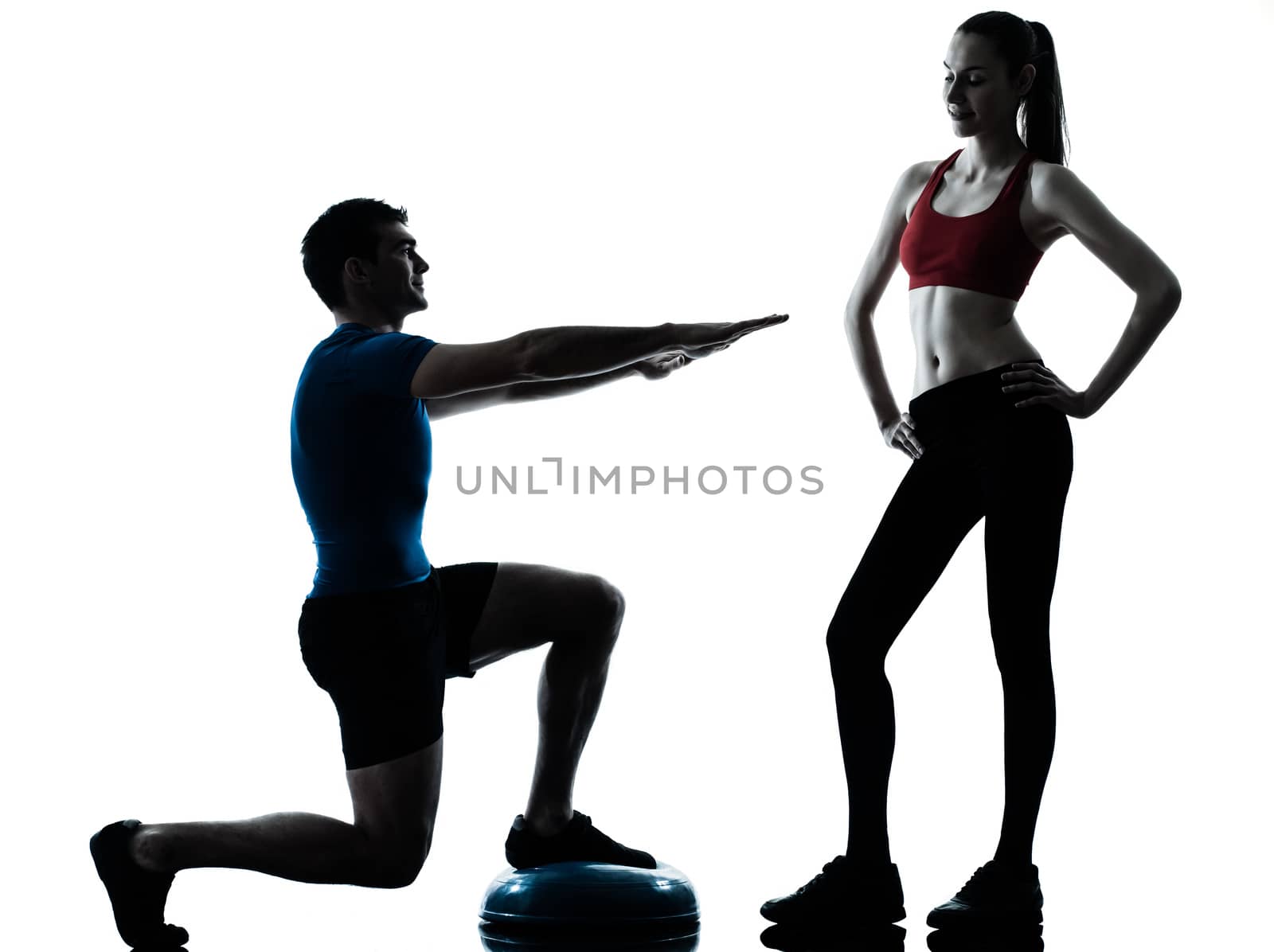 personal trainer man coach and woman exercising squats on bosu silhouette  studio isolated on white background