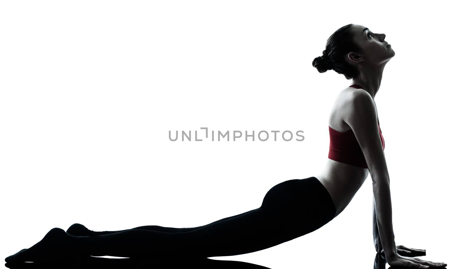 one caucasian woman sun salutation yoga surya namaskar posture position in silhouette in studio isolated on white background full length