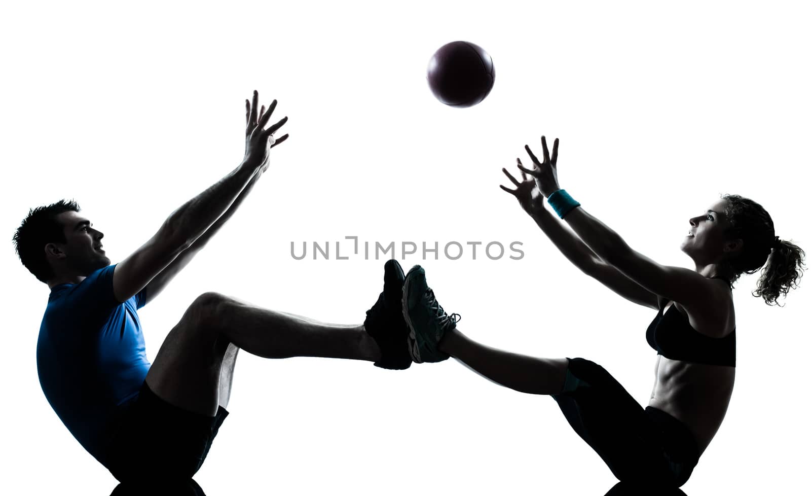 one caucasian couple man woman personal trainer coach exercising tossing fitness ball silhouette studio isolated on white background