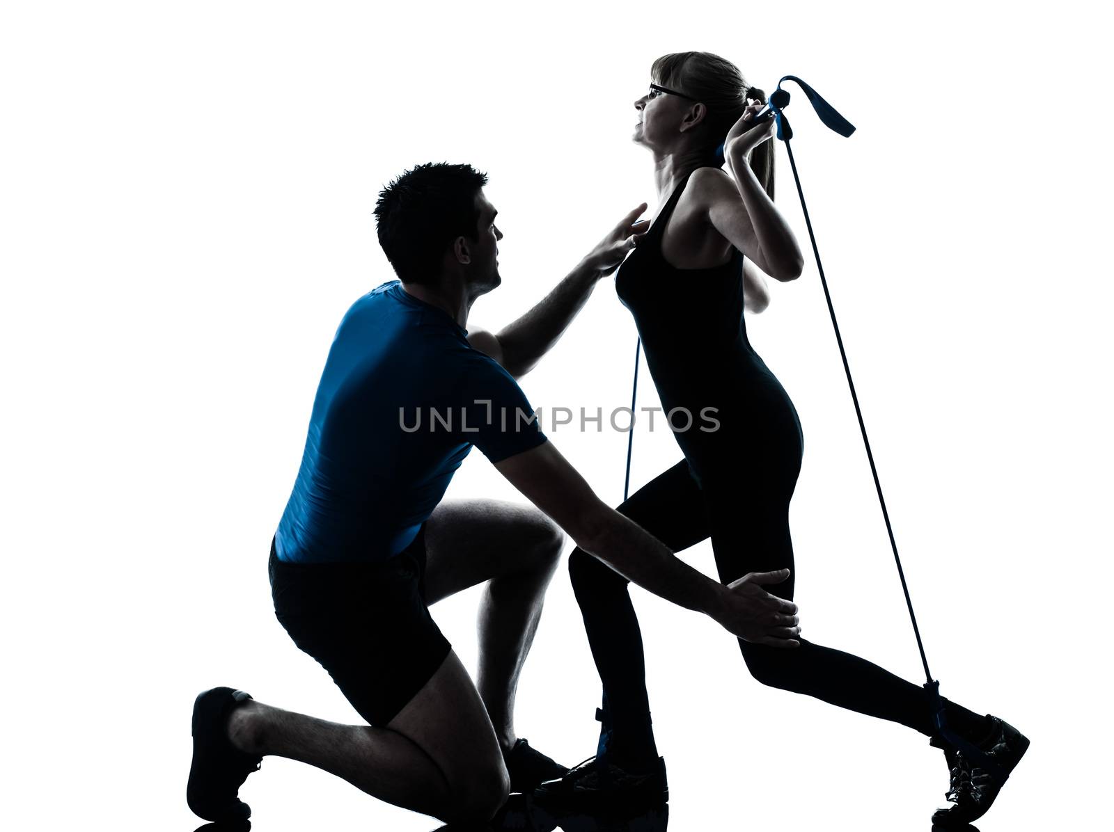 caucasian aerobics instructor  with mature woman exercising gymstick fitness workout in silhouette studio isolated on white background