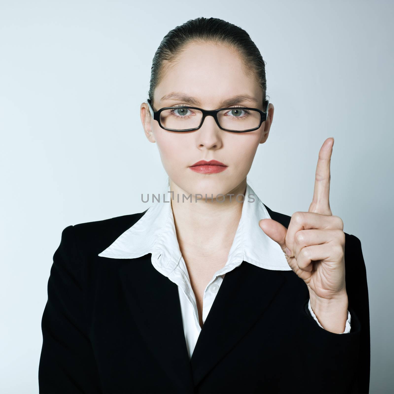 studio shot portrait of one caucasian young  teacher nanny business woman pointing up finger