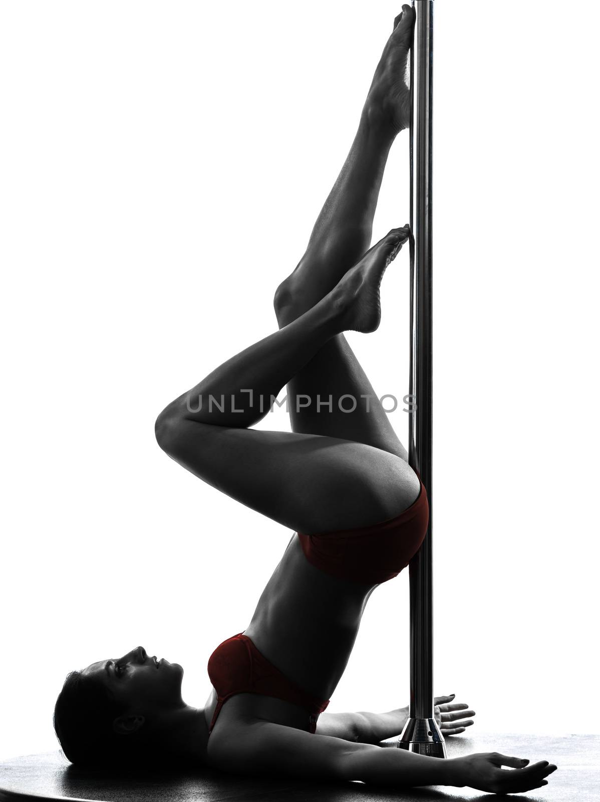 one caucasian woman pole dancer dancing in silhouette studio isolated on white background