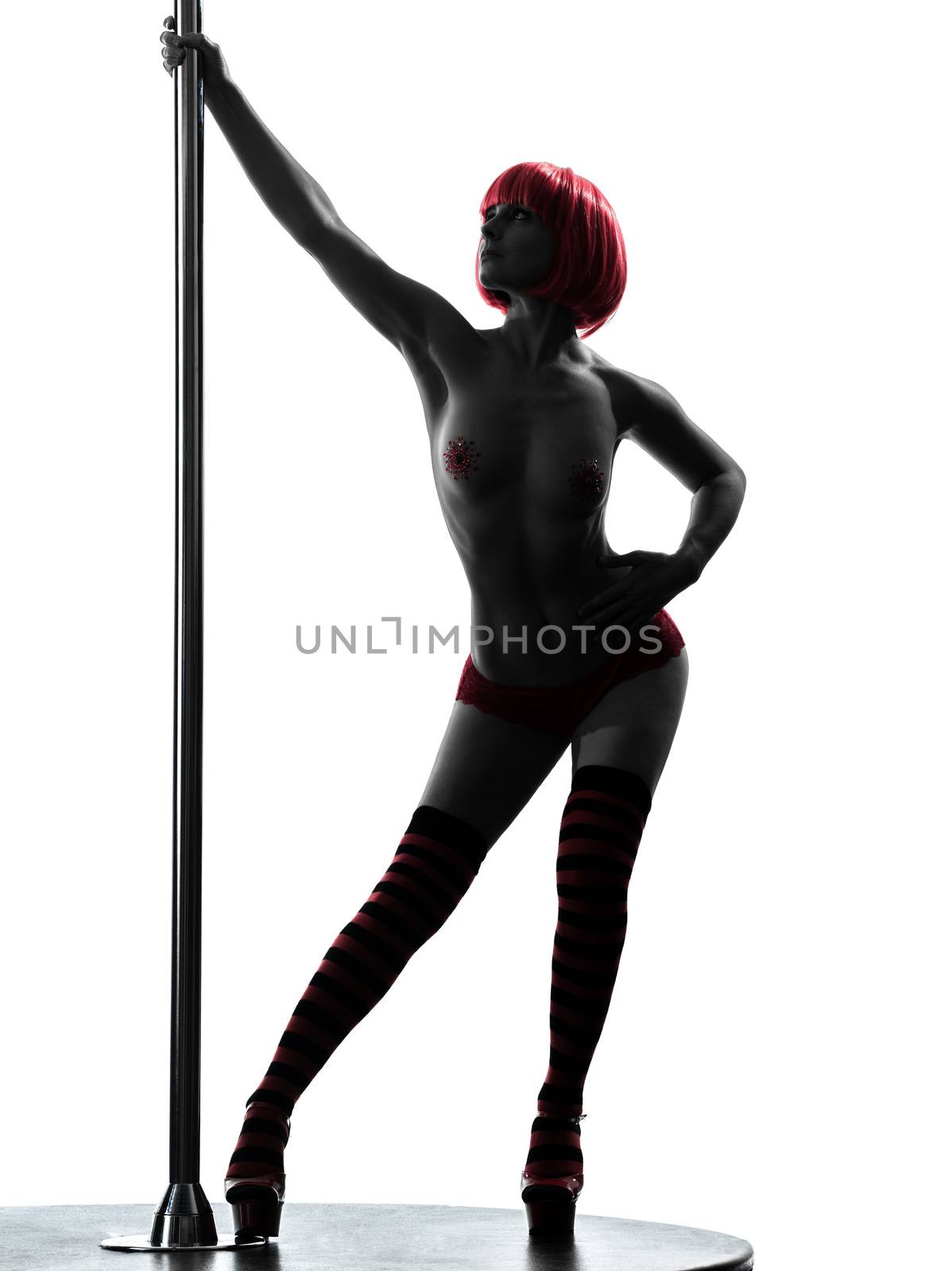 one caucasian woman pole dancer dancing in silhouette studio isolated on white background