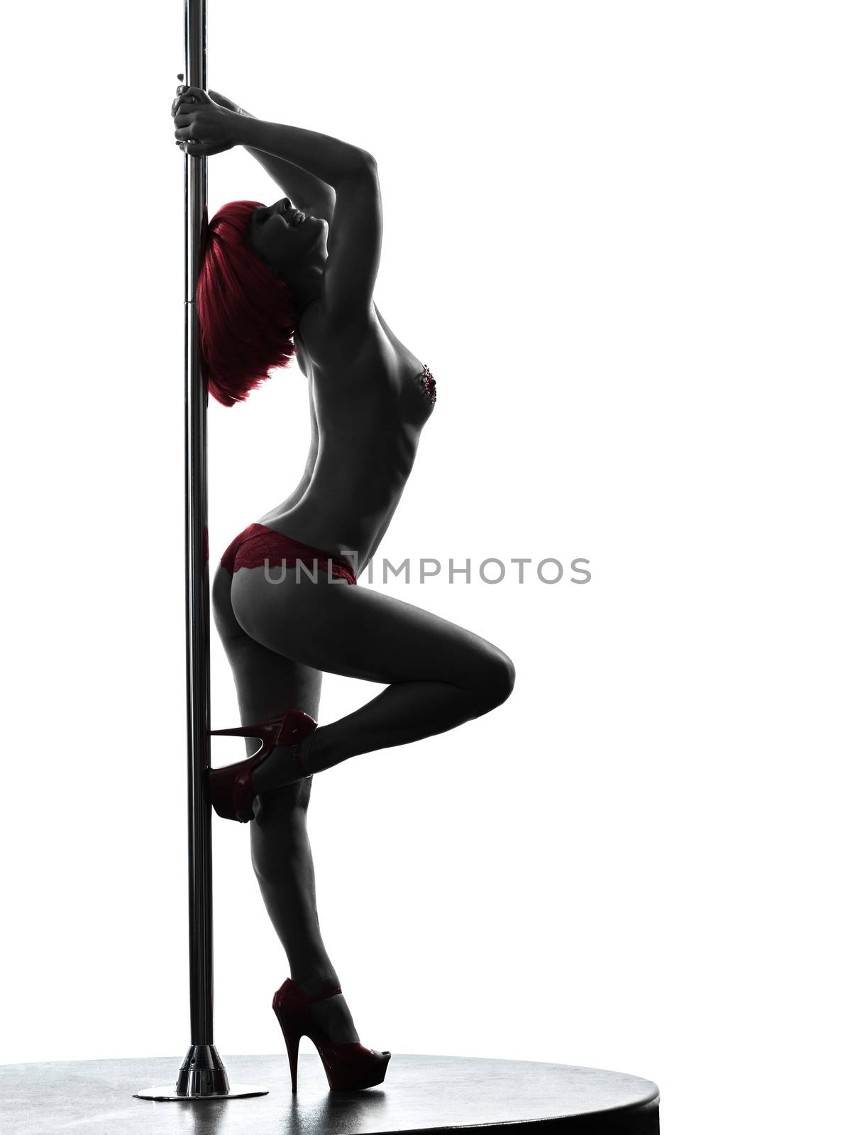 one caucasian woman pole dancer dancing in silhouette studio isolated on white background