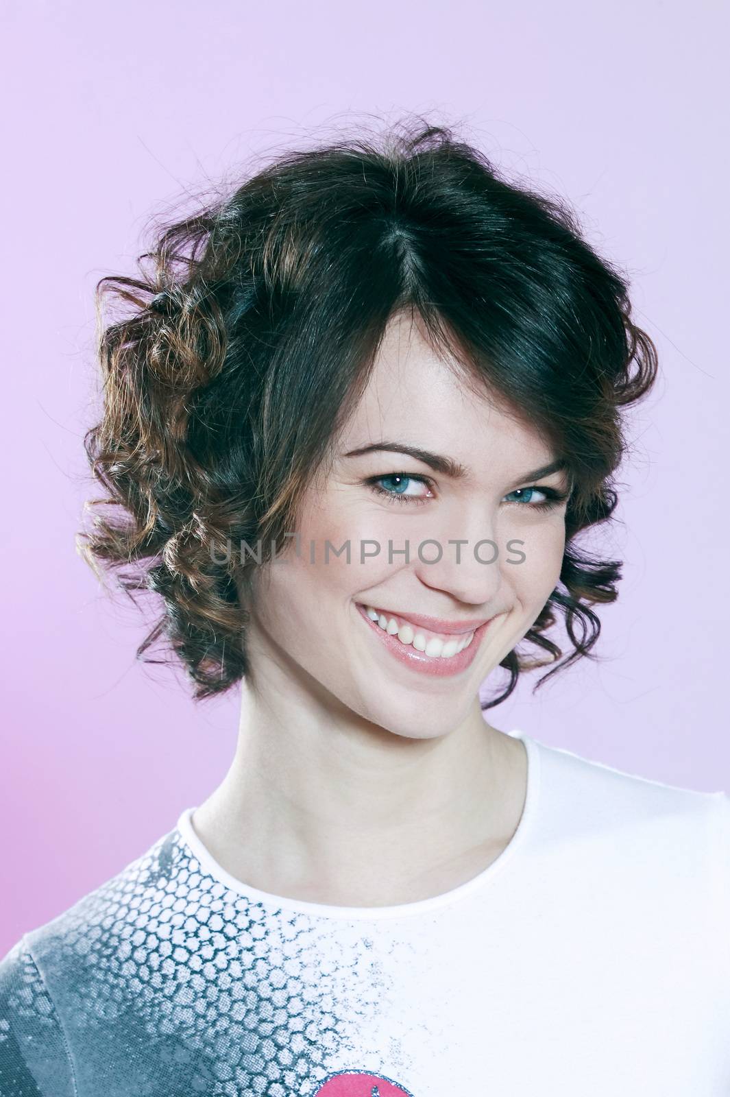 studio shots portrait of a beautiful caucasian young smiling woman on purple background