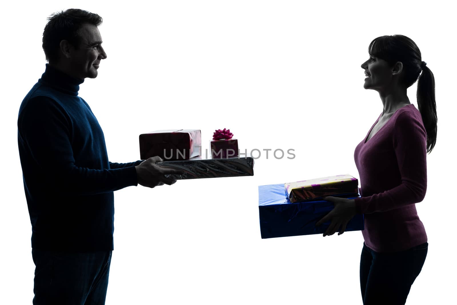 couple woman man offering christmas gifts  silhouette by PIXSTILL