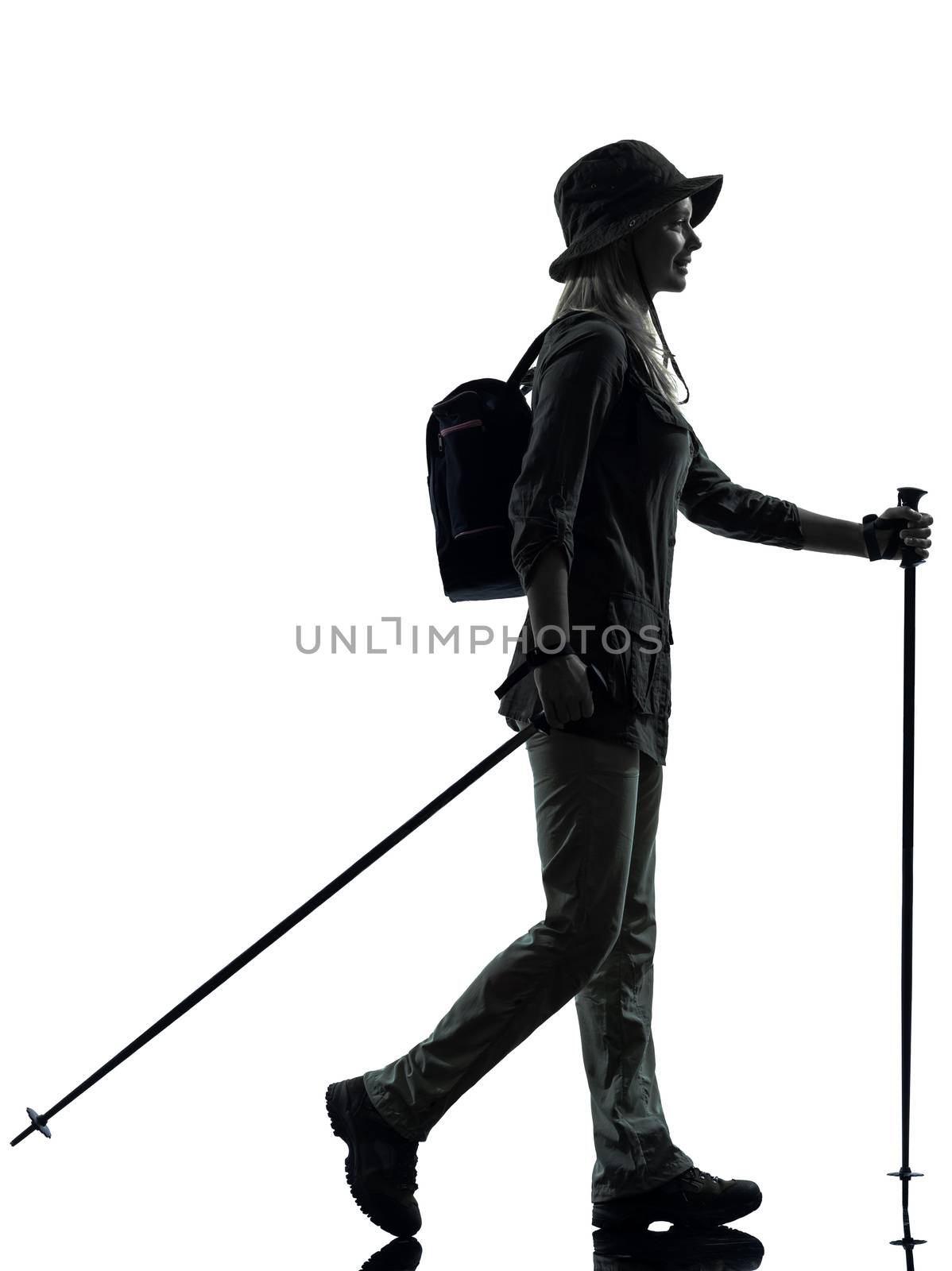 one caucasian woman trekker trekking walking in silhouette studio isolated on white background