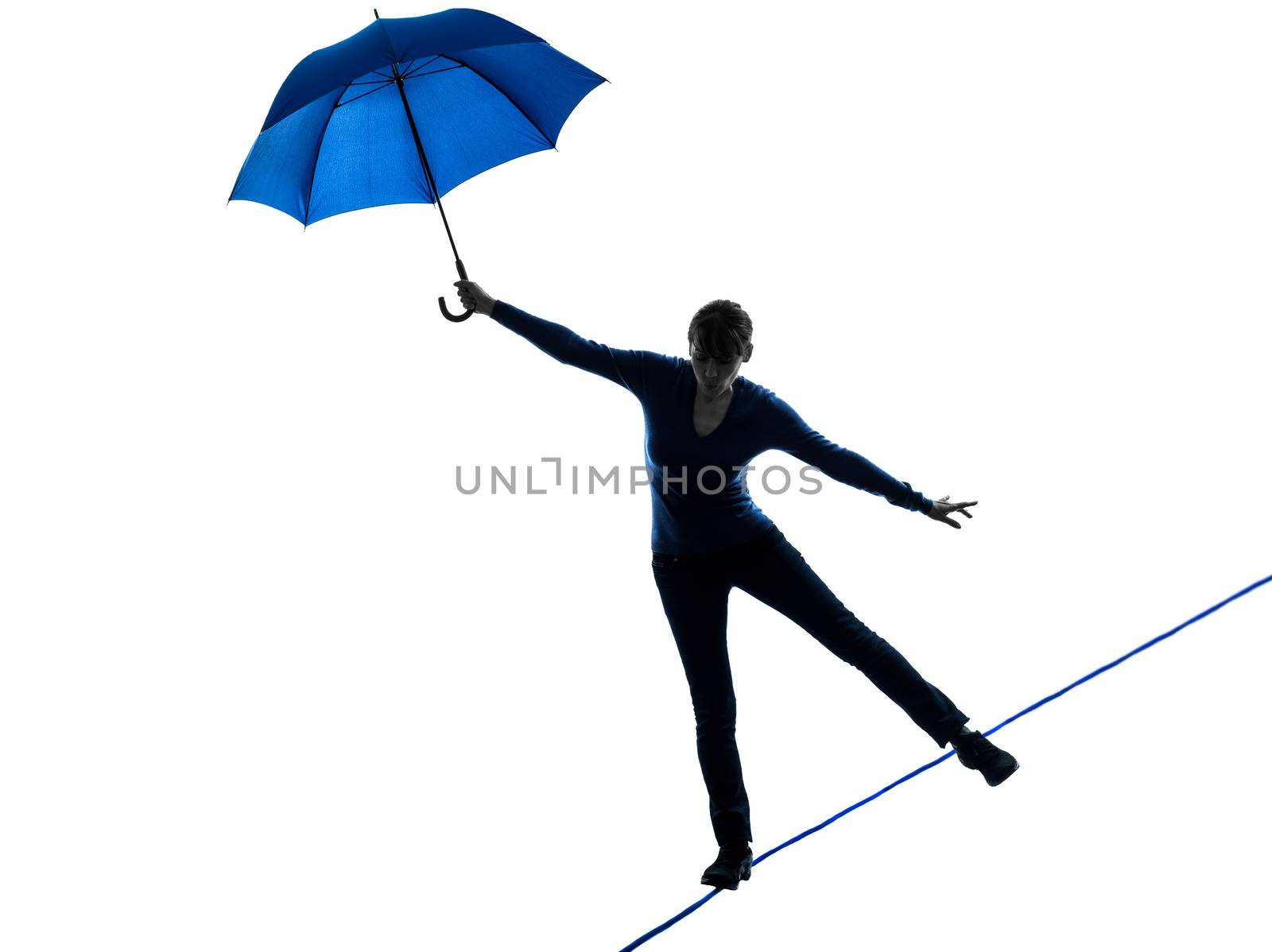 one caucasian woman holding umbrella  in silhouette studio isolated on white background