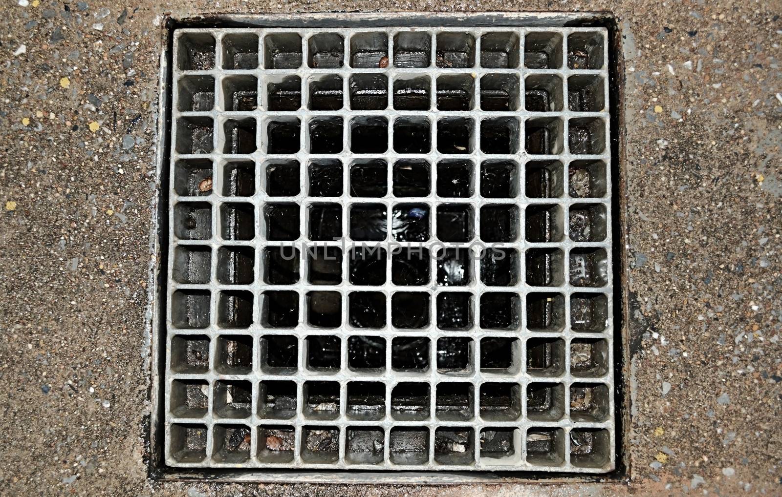 Sewer grate on the road in city