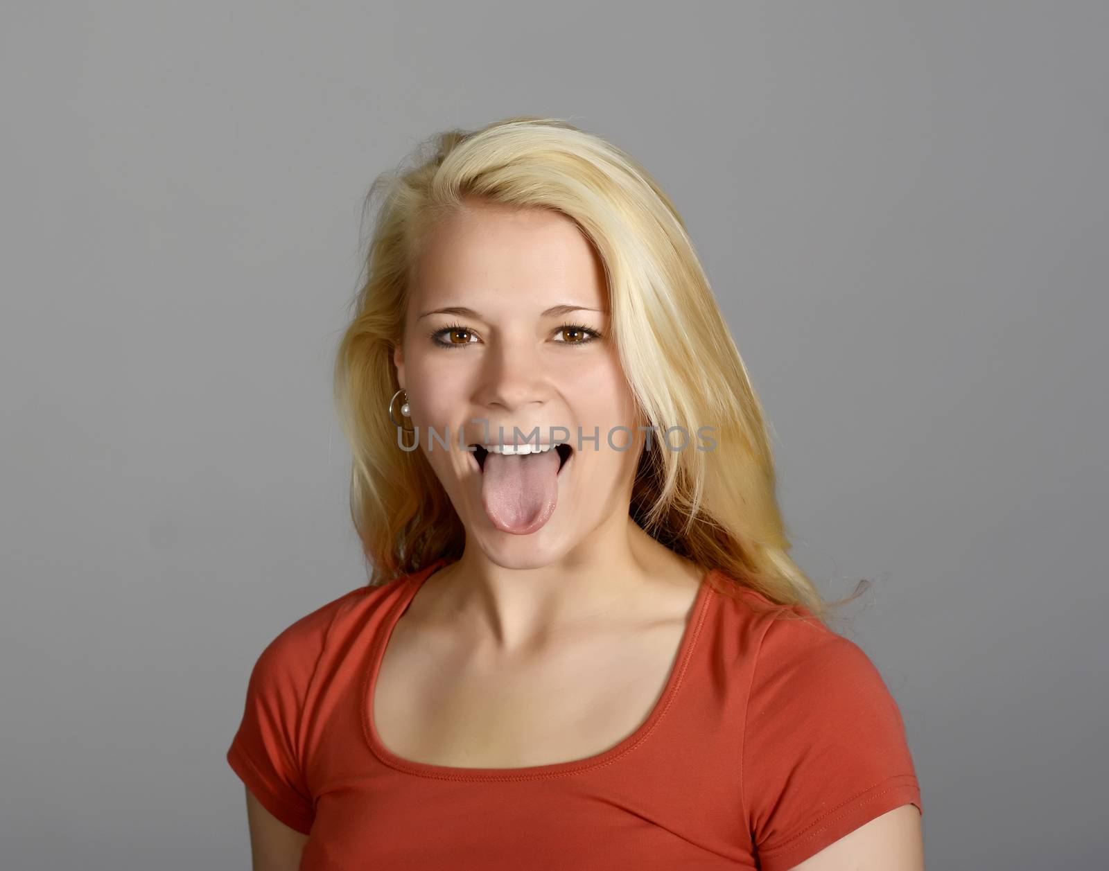 young blond woman showing her tongue
